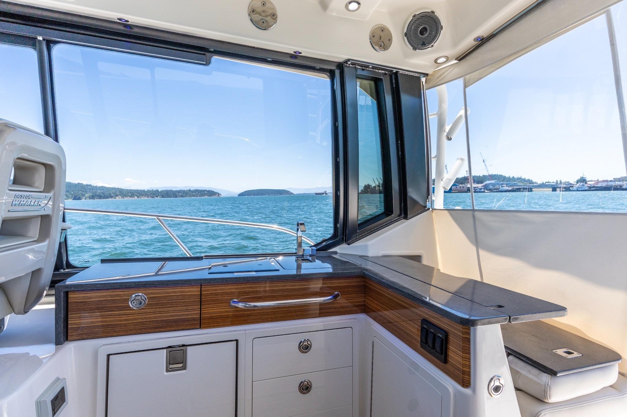 Interior view of 2023 Boston Whaler 405 Conquest yacht with ocean backdrop.