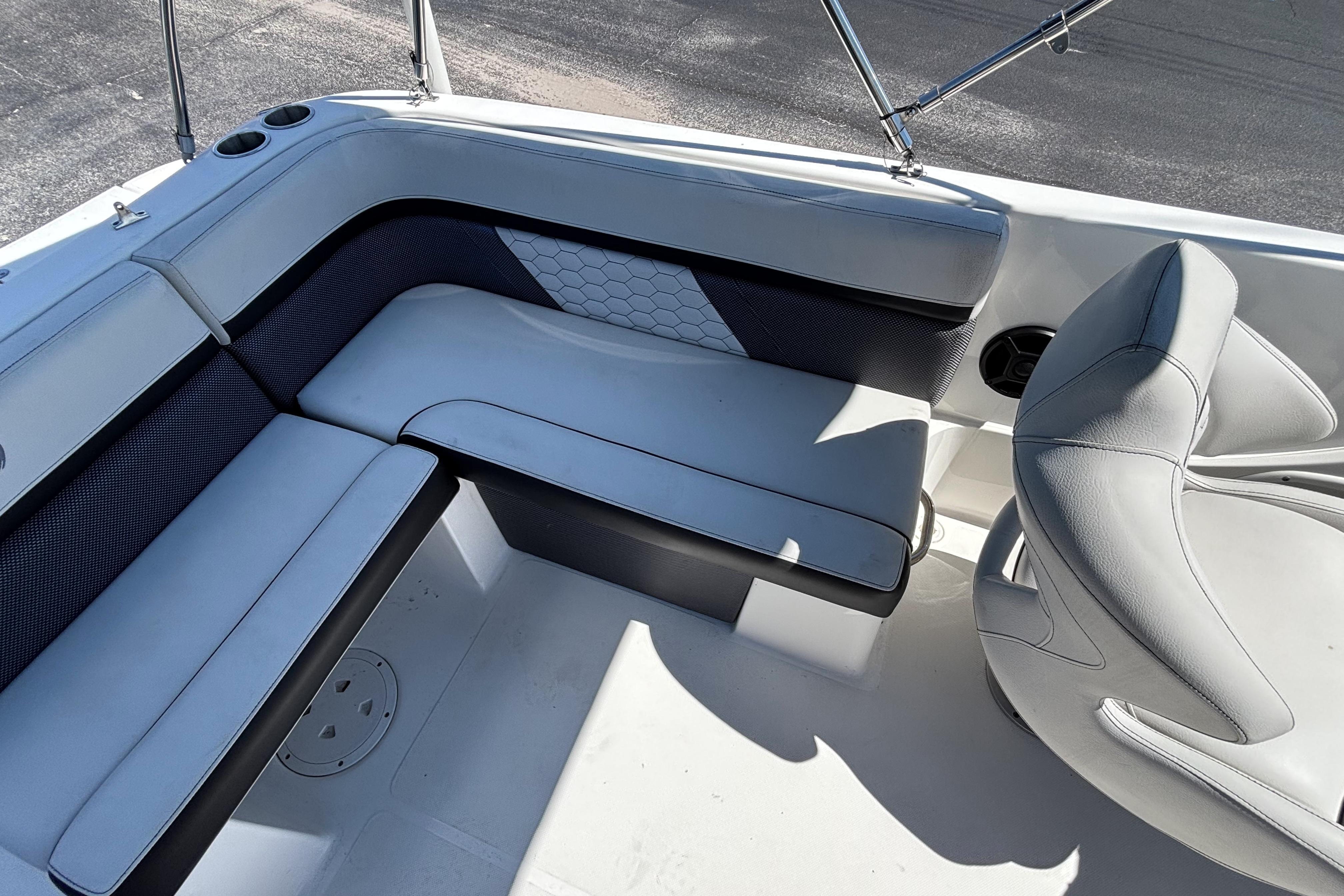 2019 Hurricane Sundeck Sport 218 OB boat interior with cushioned seating and cup holders.