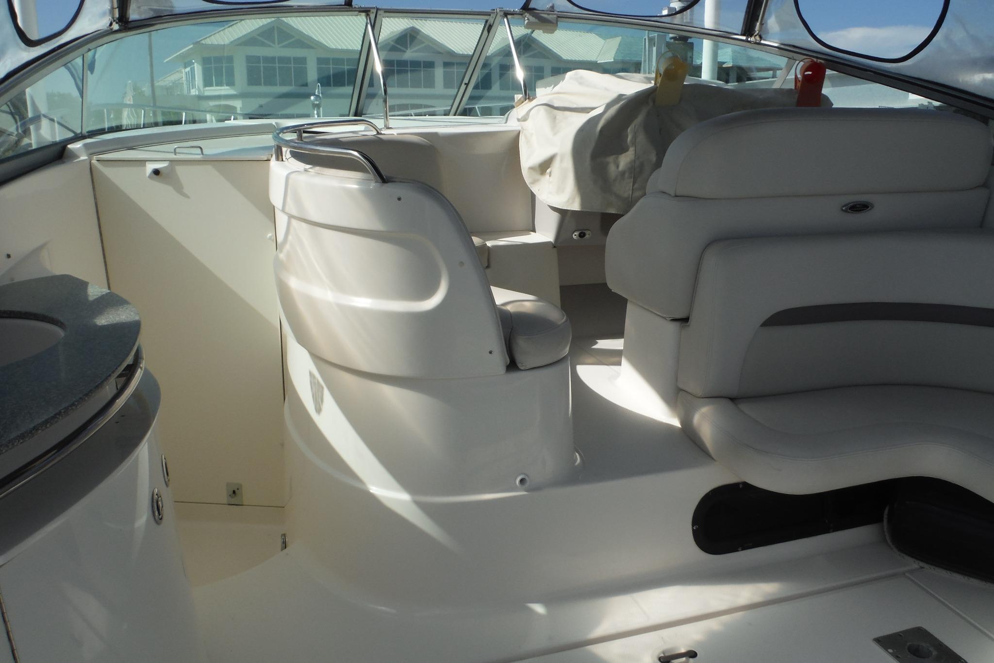 Interior of a 2005 Chaparral Signature 350 boat with white seating and helm.