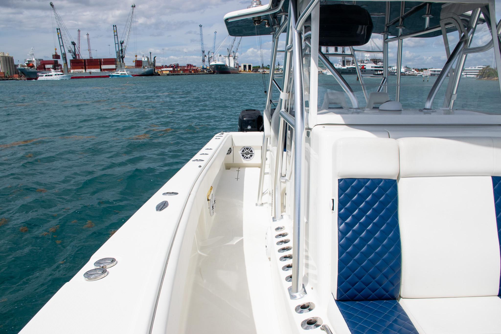 2022 SeaVee 390Z boat with blue and white seating, docked in a harbor.