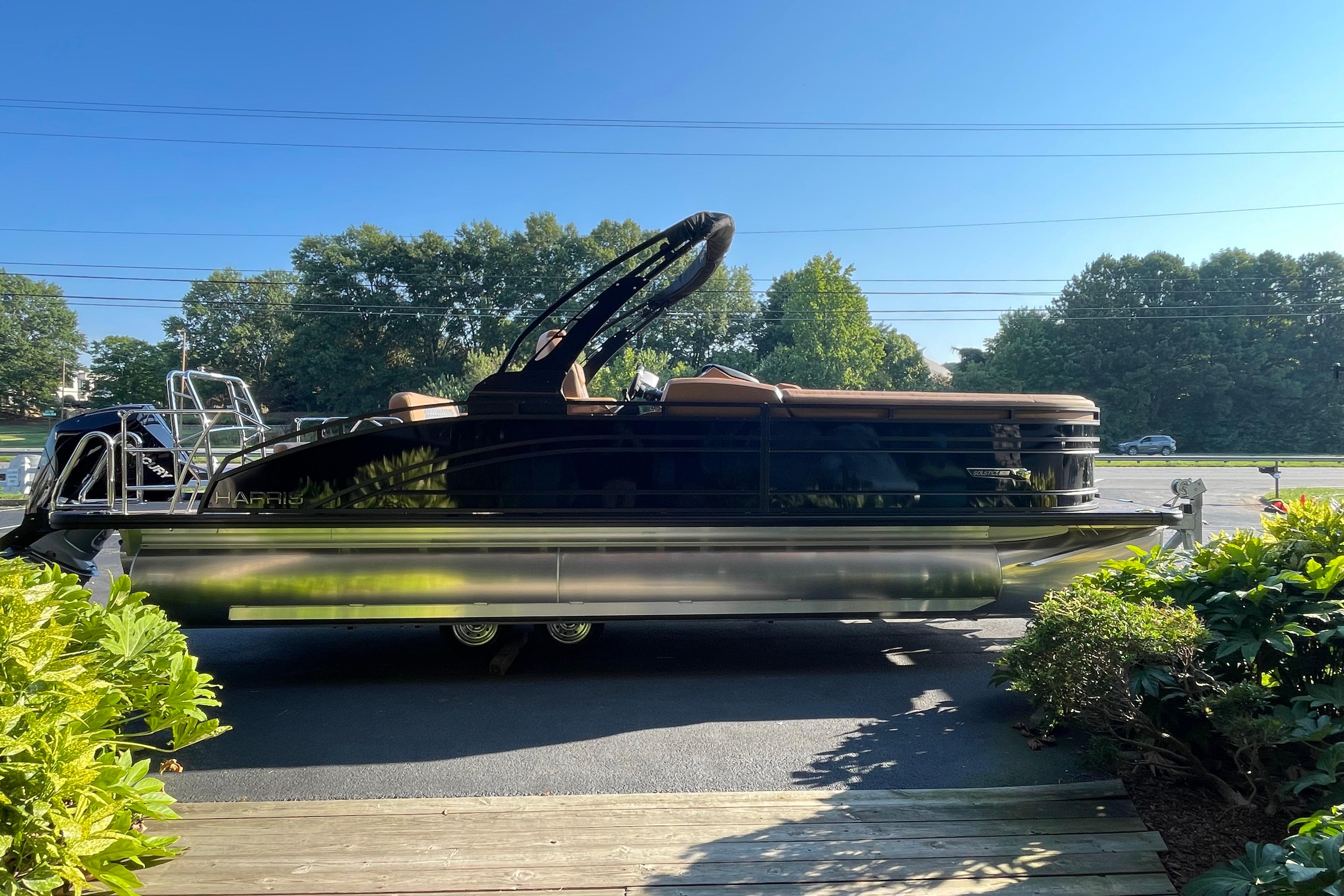 2026 Harris Solstice 250 SLDH pontoon boat parked on a sunny day.