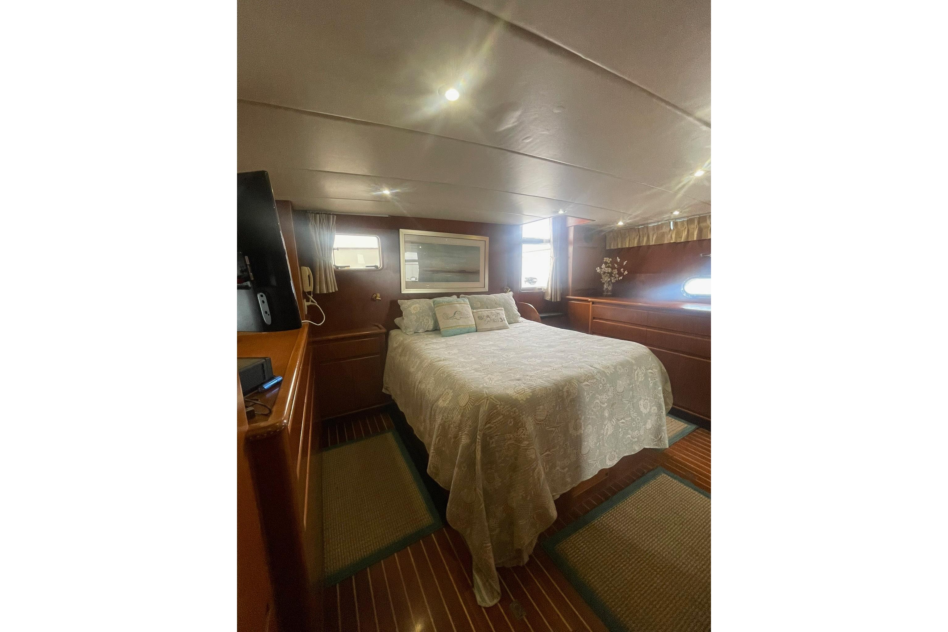 Luxurious bedroom interior of 2001 Novatec Islander yacht with elegant decor and cozy ambiance.