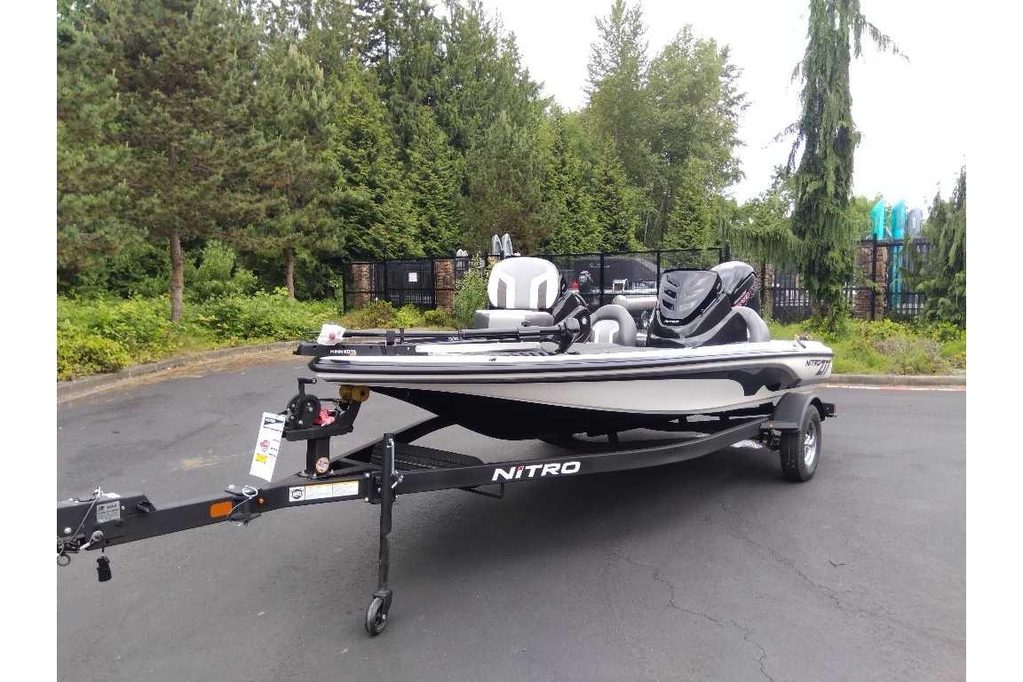 2026 Nitro Z17 boat on trailer, parked outdoors with lush greenery background.
