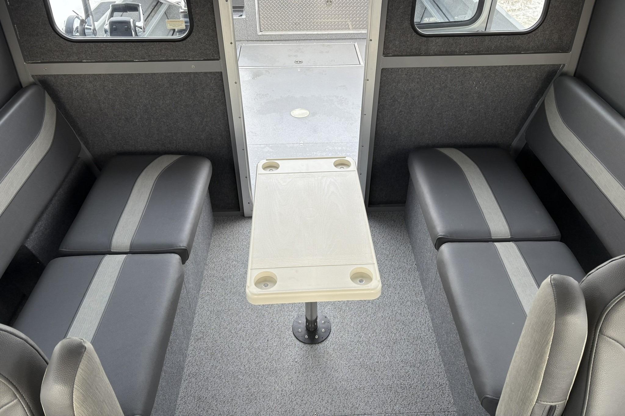 2024 Spartan 26 Maximus Pro XL interior with seating and table setup.