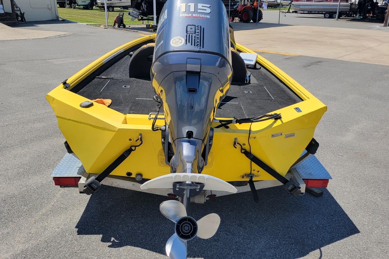 Yellow Excel 1751 F4 boat with Yamaha 115 outboard motor, parked on a trailer.