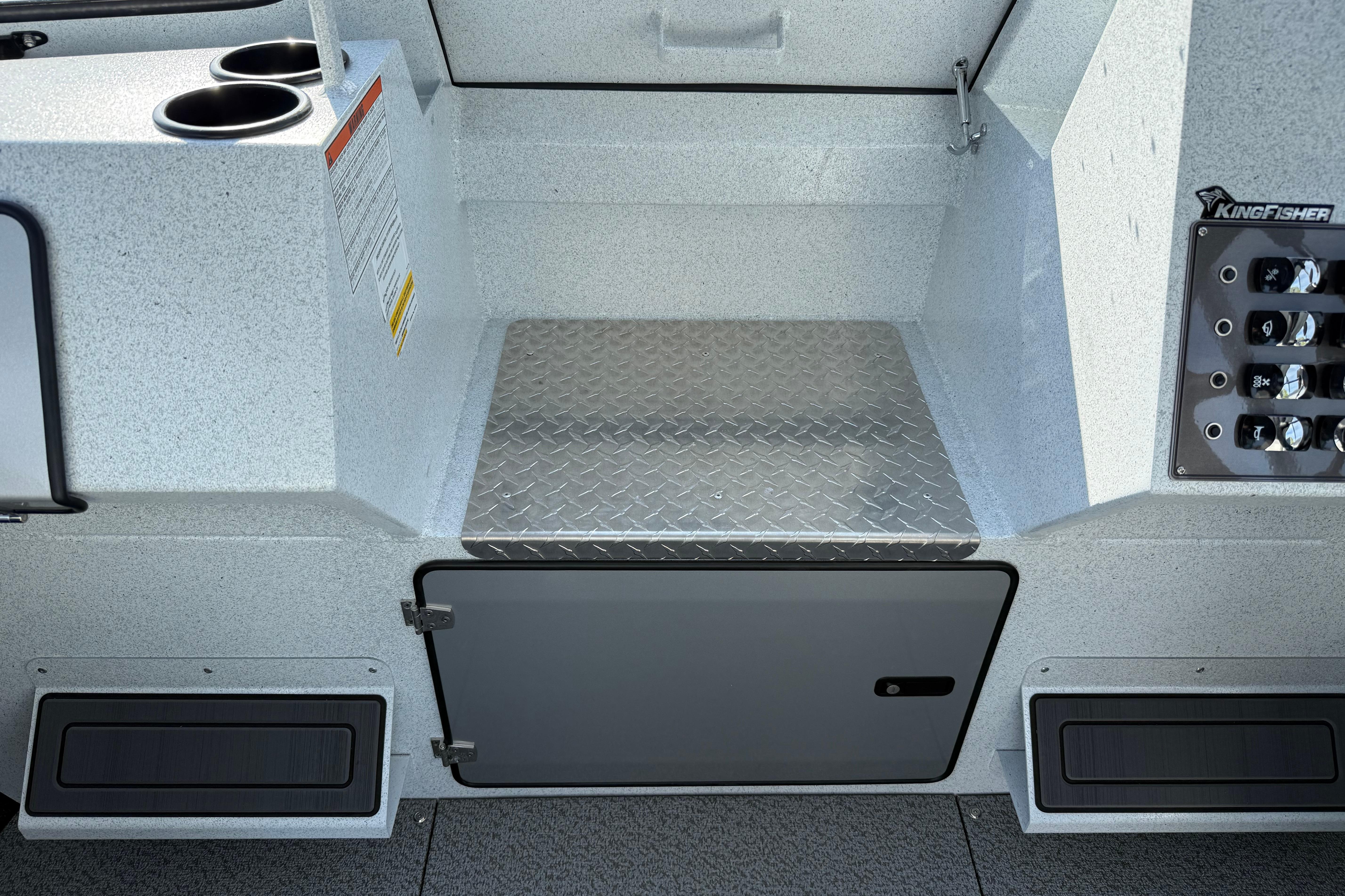 Interior of 2026 KingFisher 2425 Escape HT boat with storage and control panel.