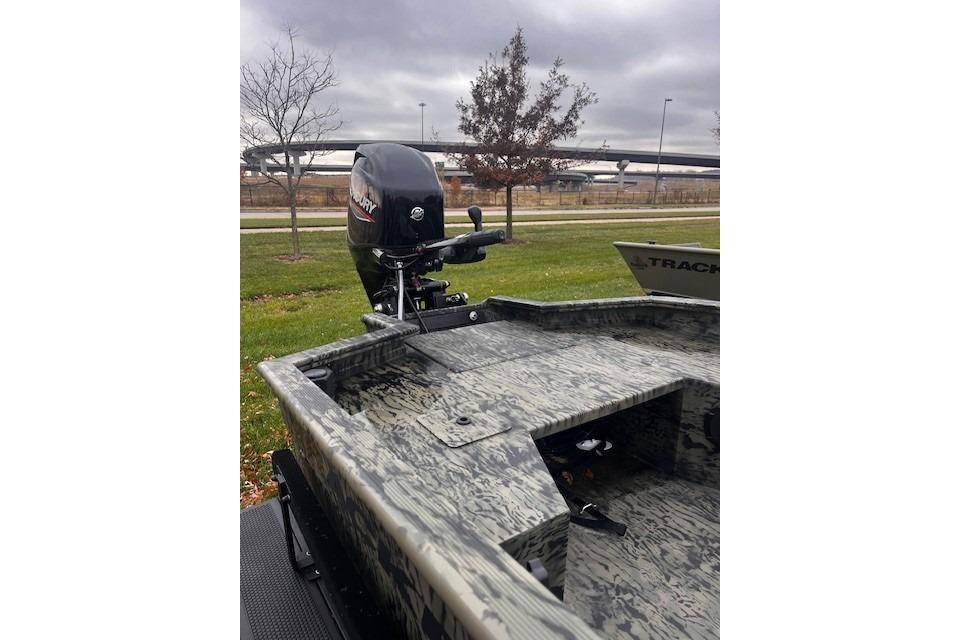 2026 Tracker Grizzly 1650 T Prairie Wings Edition boat with camo design and outboard motor.