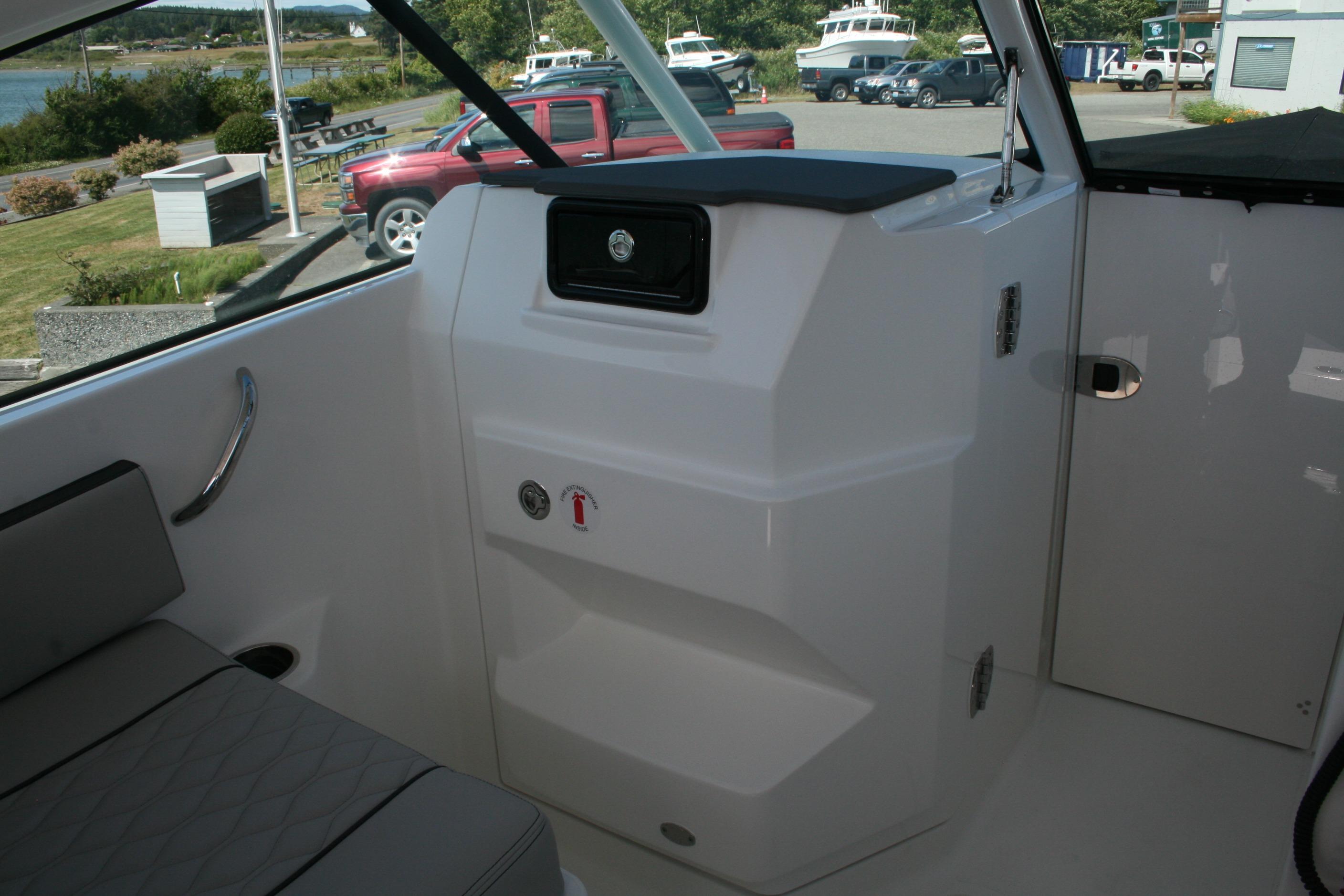 Interior view of 2026 Pursuit DC 266 Dual Console boat, showcasing seating and storage.