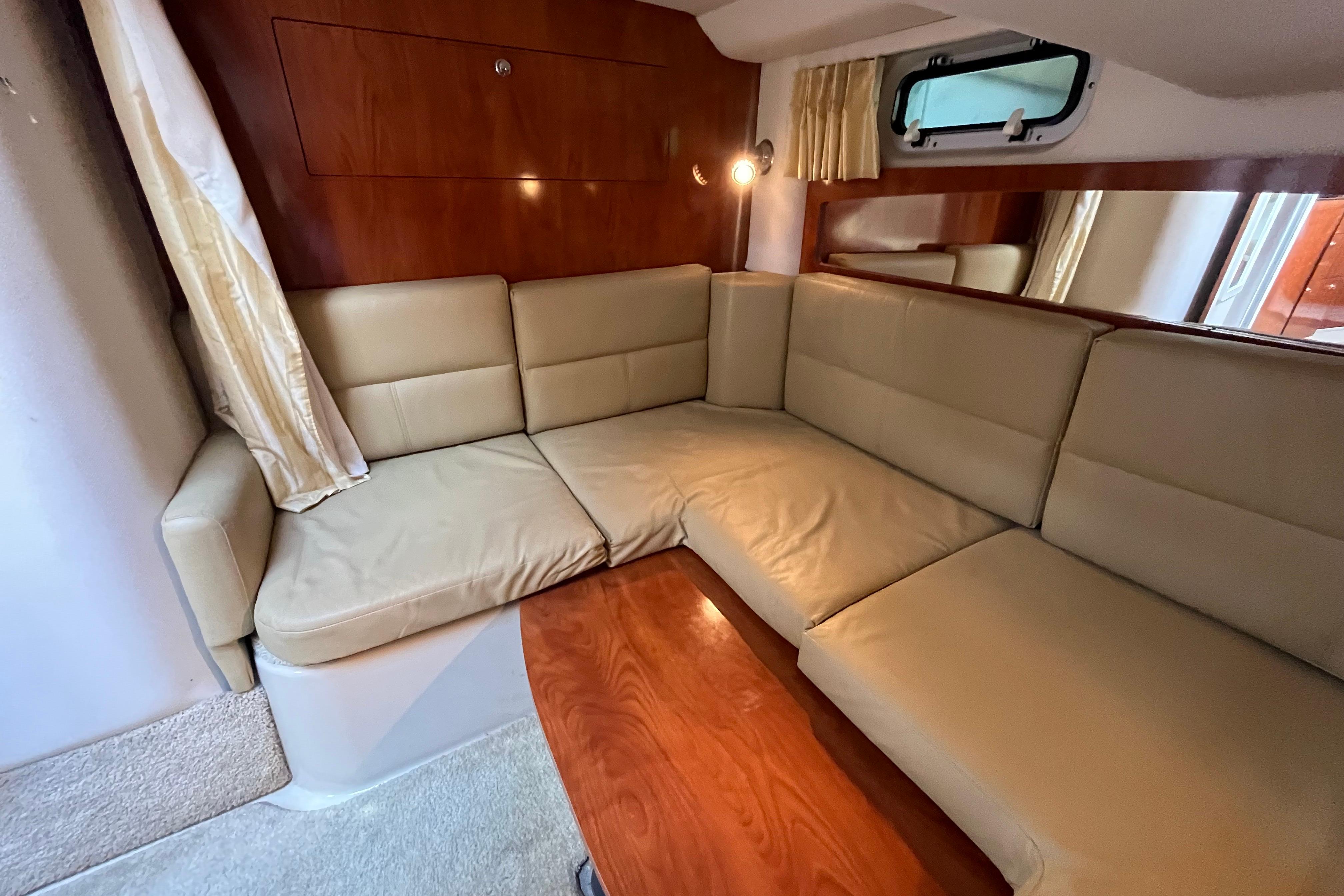 Interior of 2008 Four Winns 338 Vista yacht with beige leather seating and wooden accents.