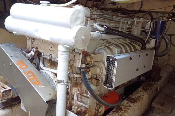 Engine room of a 1980 Thompson Passenger and Dive Trawler, featuring a robust marine engine.