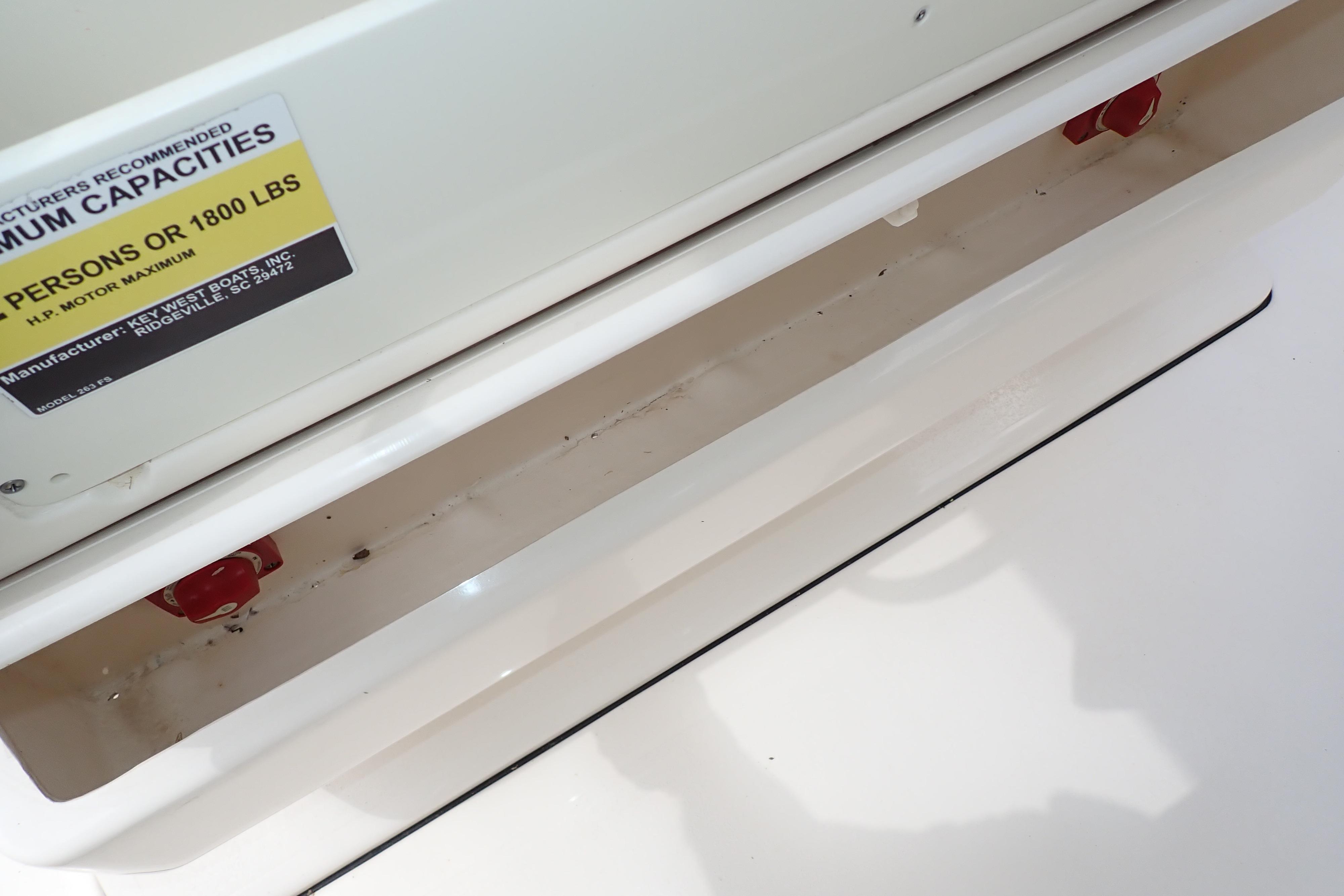 2019 Key West 263 FS boat capacity label and storage compartment detail.