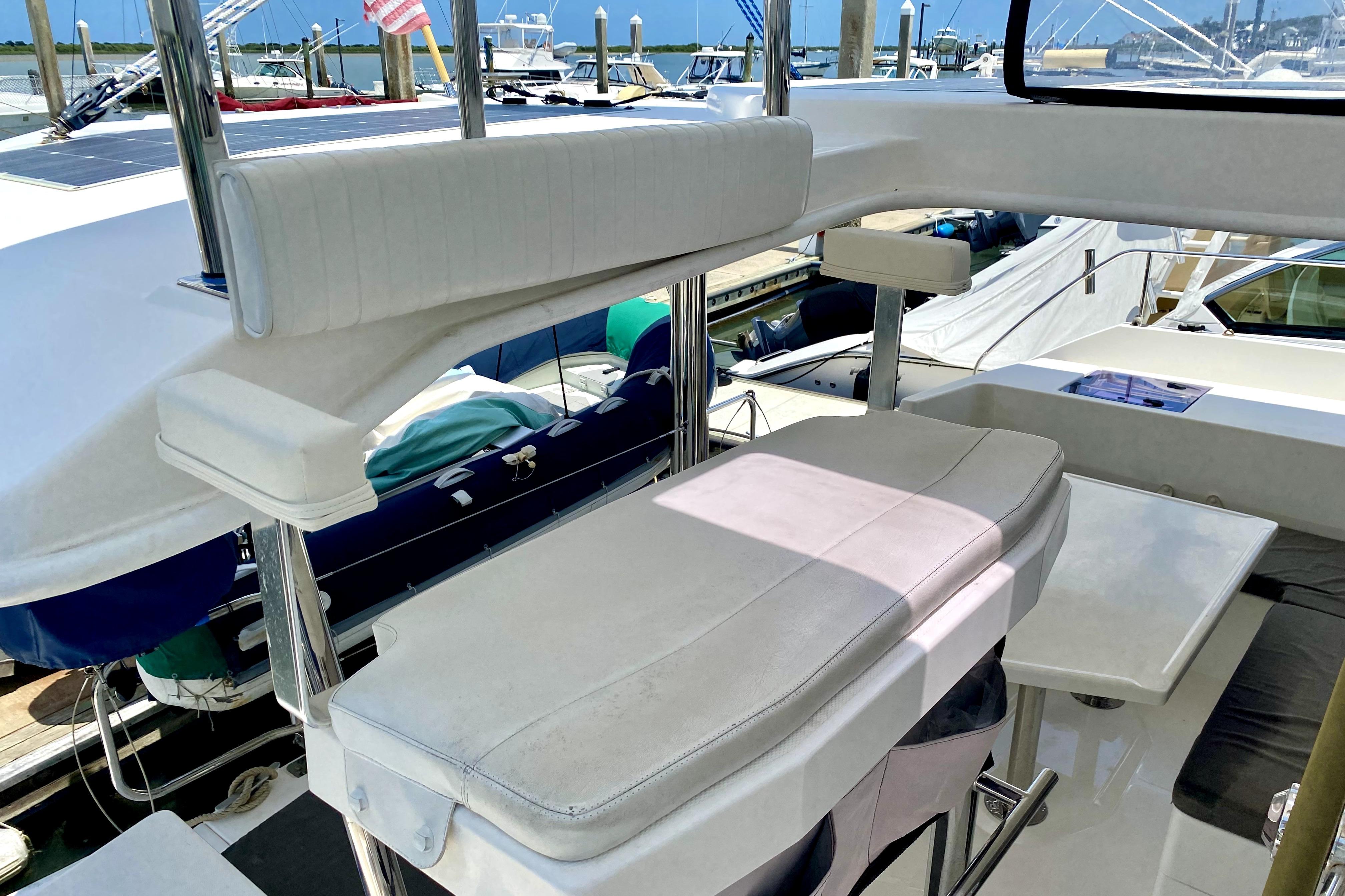 Flybridge seating area on a 2017 Leopard 40 catamaran, docked at a marina.