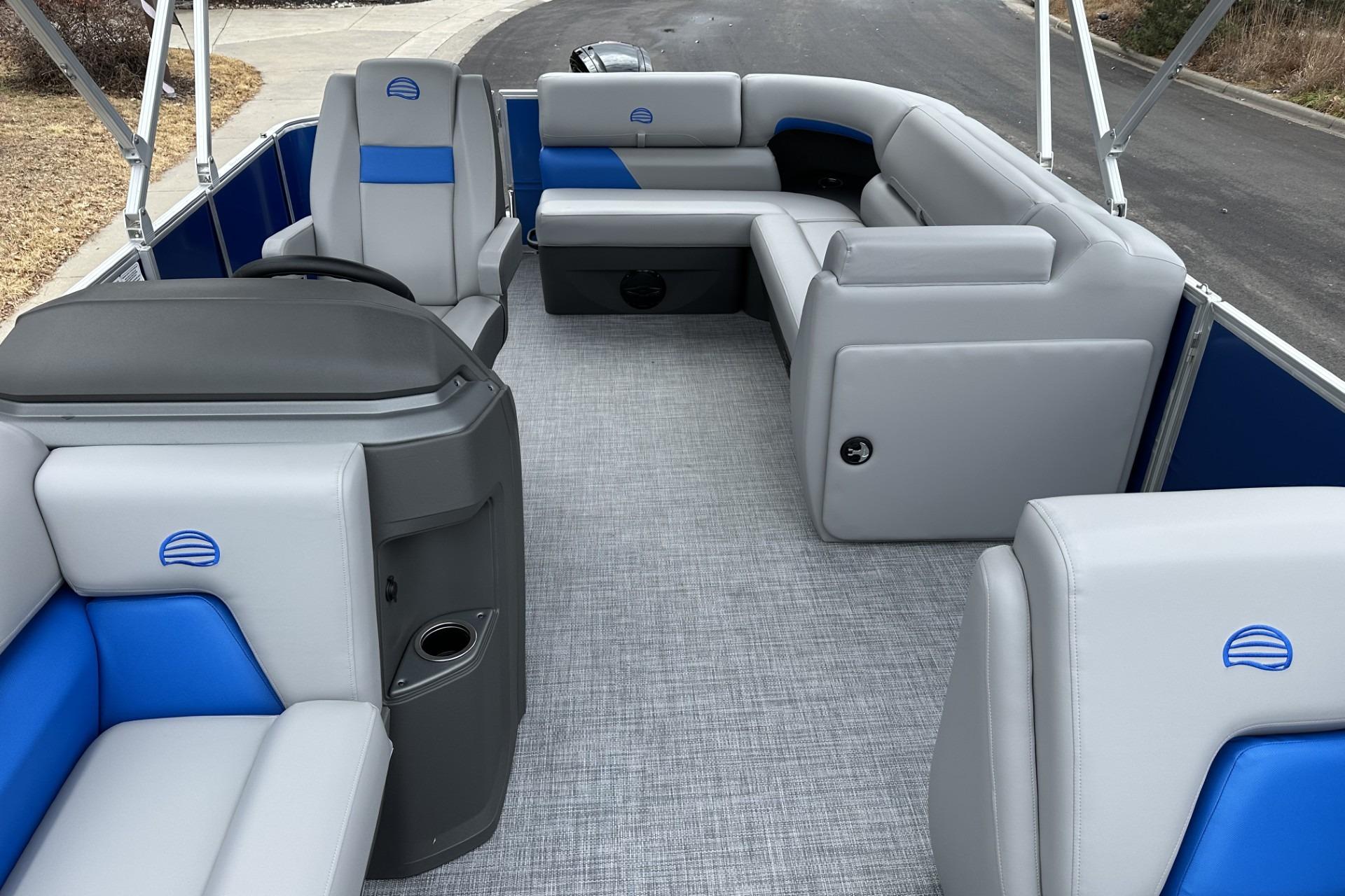 2026 Sun Tracker Party Barge 20 DLX interior with gray and blue seating.