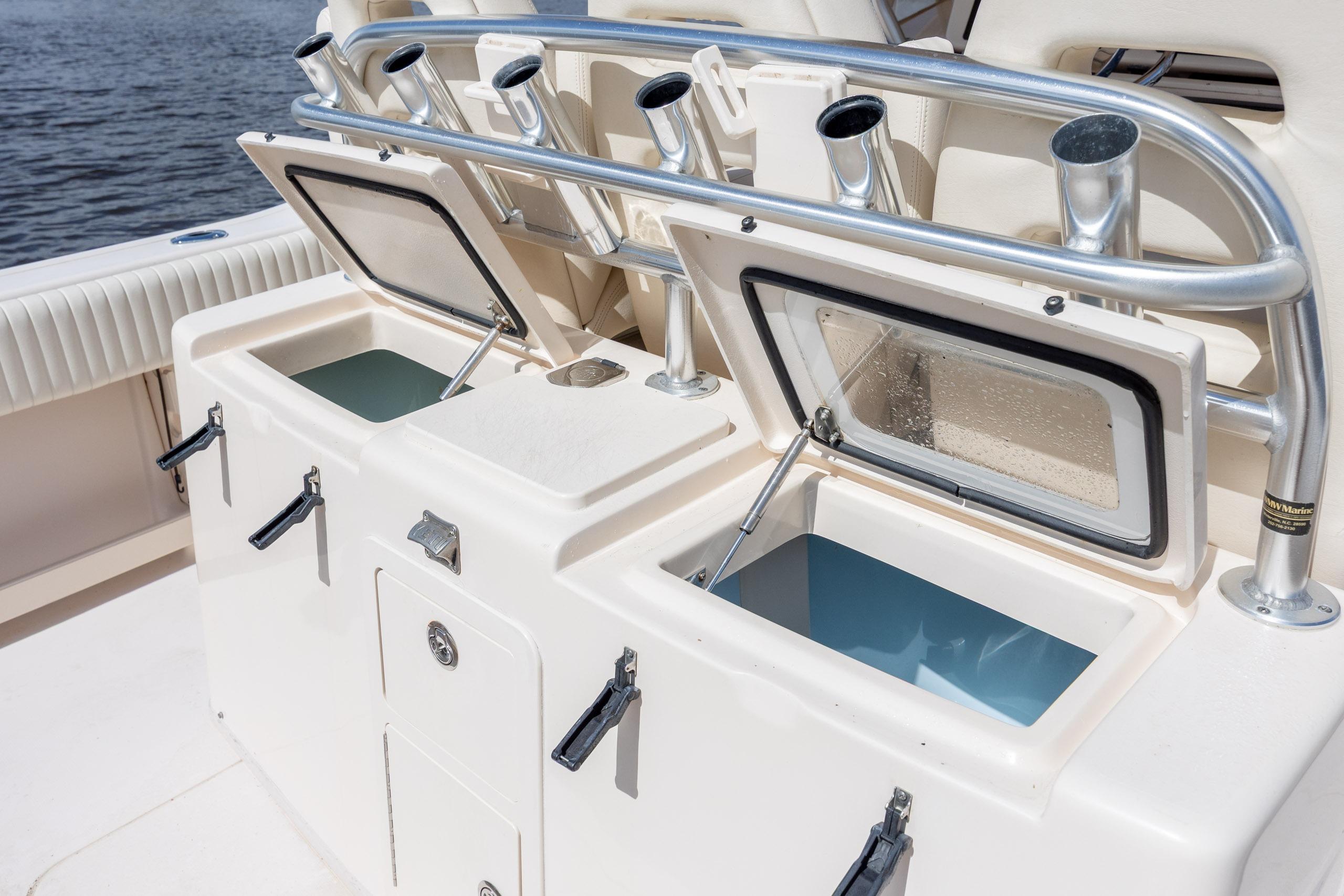 2013 Grady-White Canyon 306 boat with open storage compartments and rod holders.