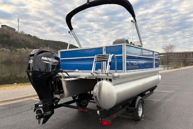 2026 Sun Tracker Party Barge 16 DLX pontoon boat with Mercury engine on trailer.