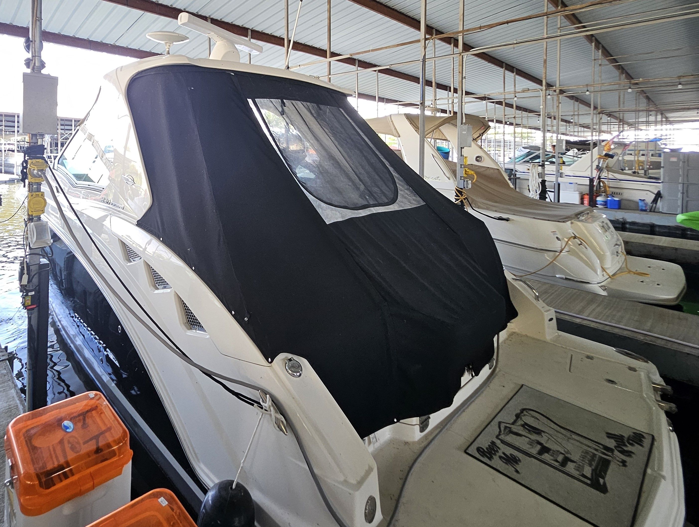 2014 Chaparral 330 Signature yacht docked with cover.