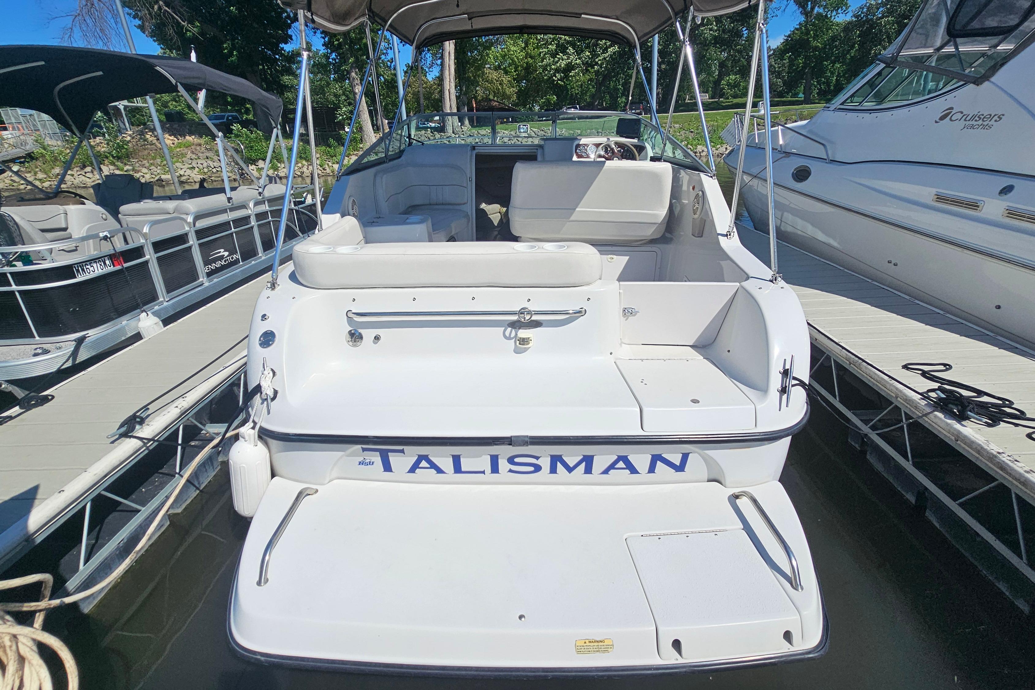 2000 Crownline 242 CR boat named "Talisman" docked at a marina.