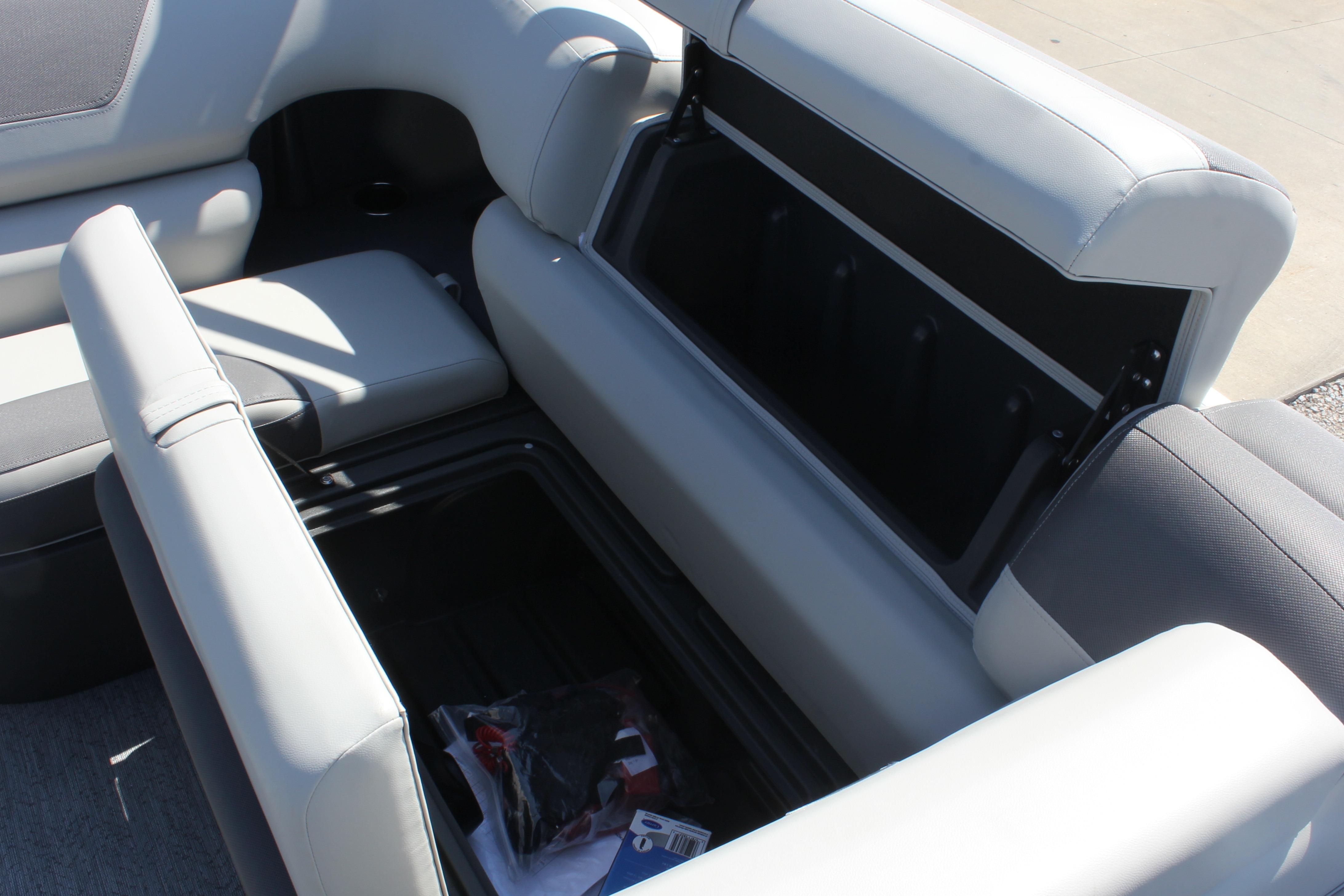 Open storage compartment on 2026 Sun Tracker Fishin' Barge 20 DLX boat.