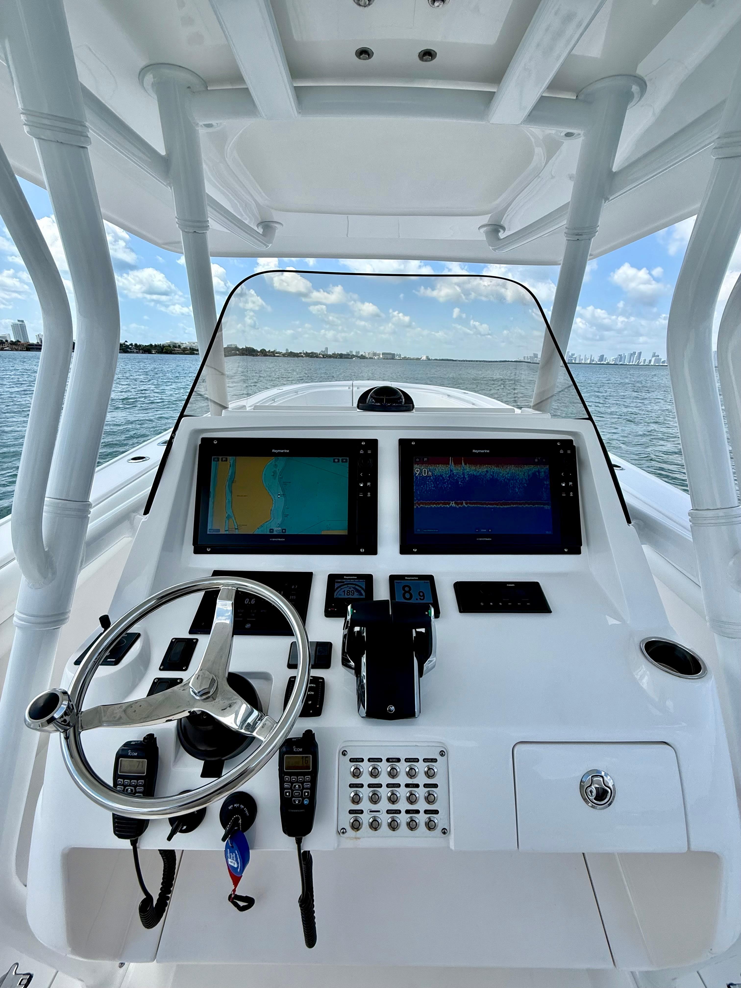 2015 Intrepid 375 Center Console boat dashboard with navigation screens and steering wheel.