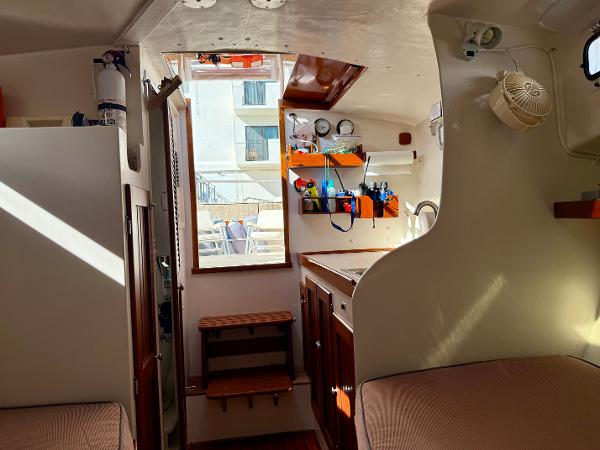1978 Dyer 29 Trunk Cabin interior with wooden accents and organized shelves.