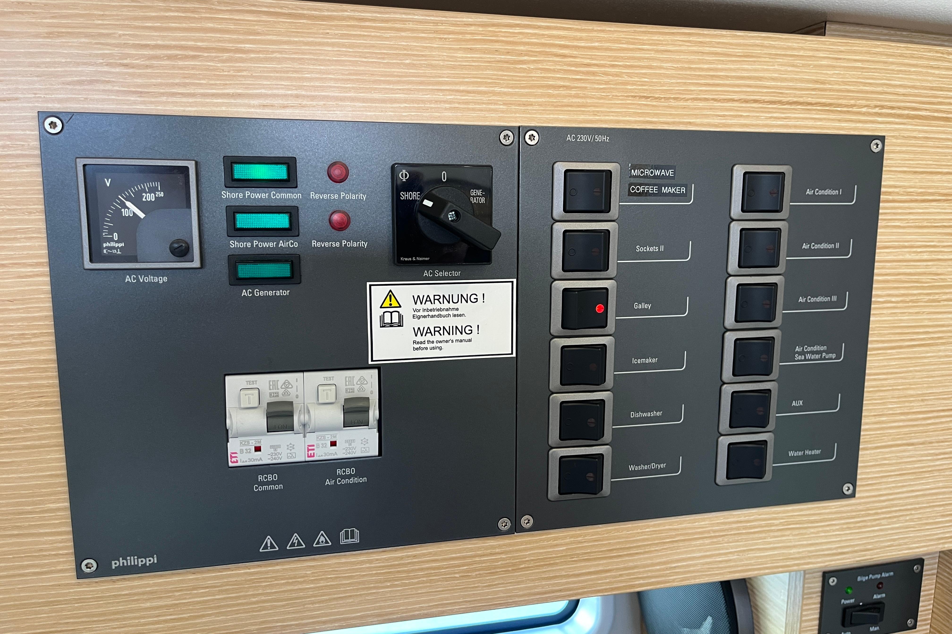Electrical control panel on a 2025 Hanse 360 yacht, featuring various switches and indicators.