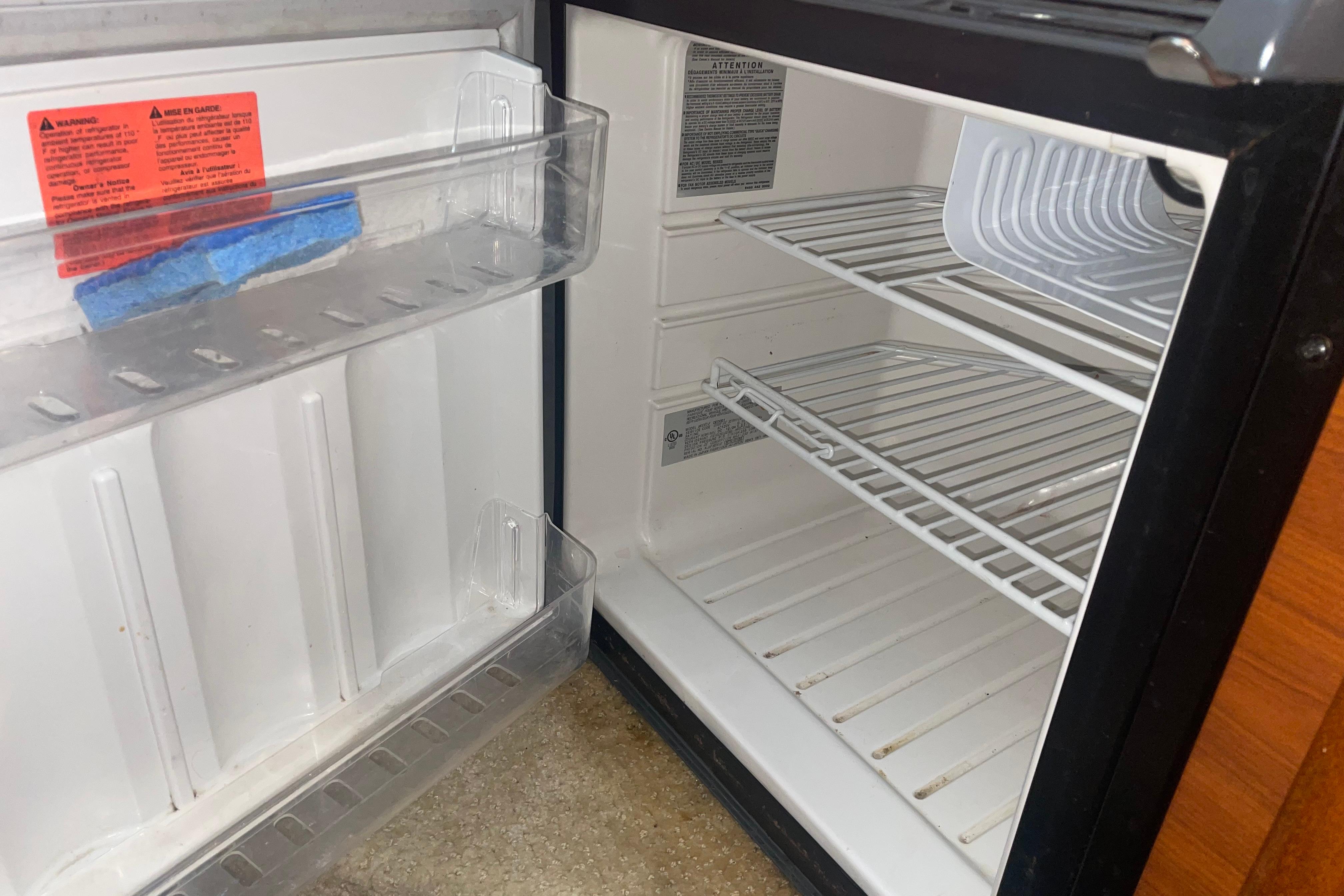 Empty refrigerator inside a 2006 Sea Ray Sundancer 260 boat.