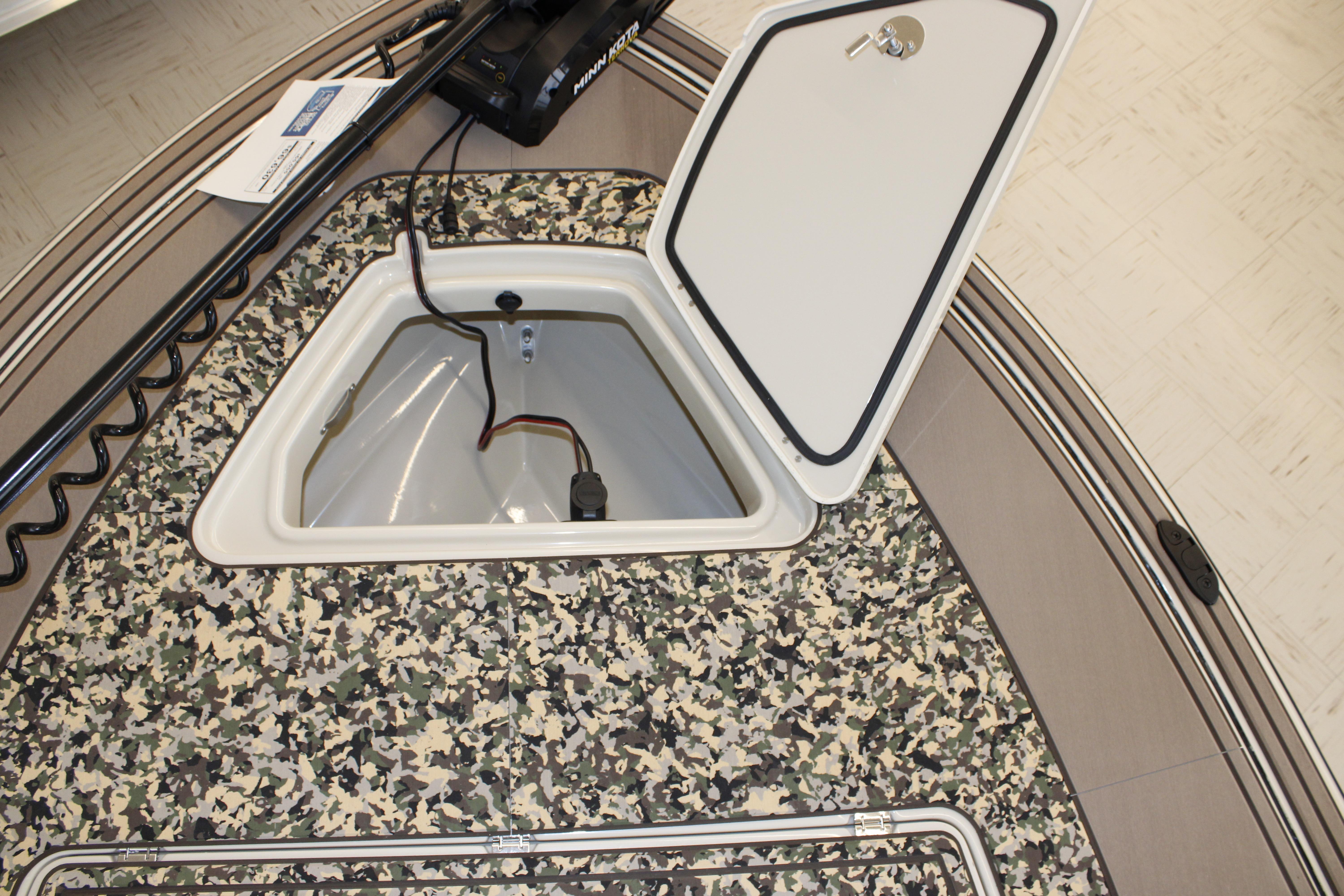 2026 Mako 18 Pro Skiff Backwater Edition with open storage compartment and camouflage deck.