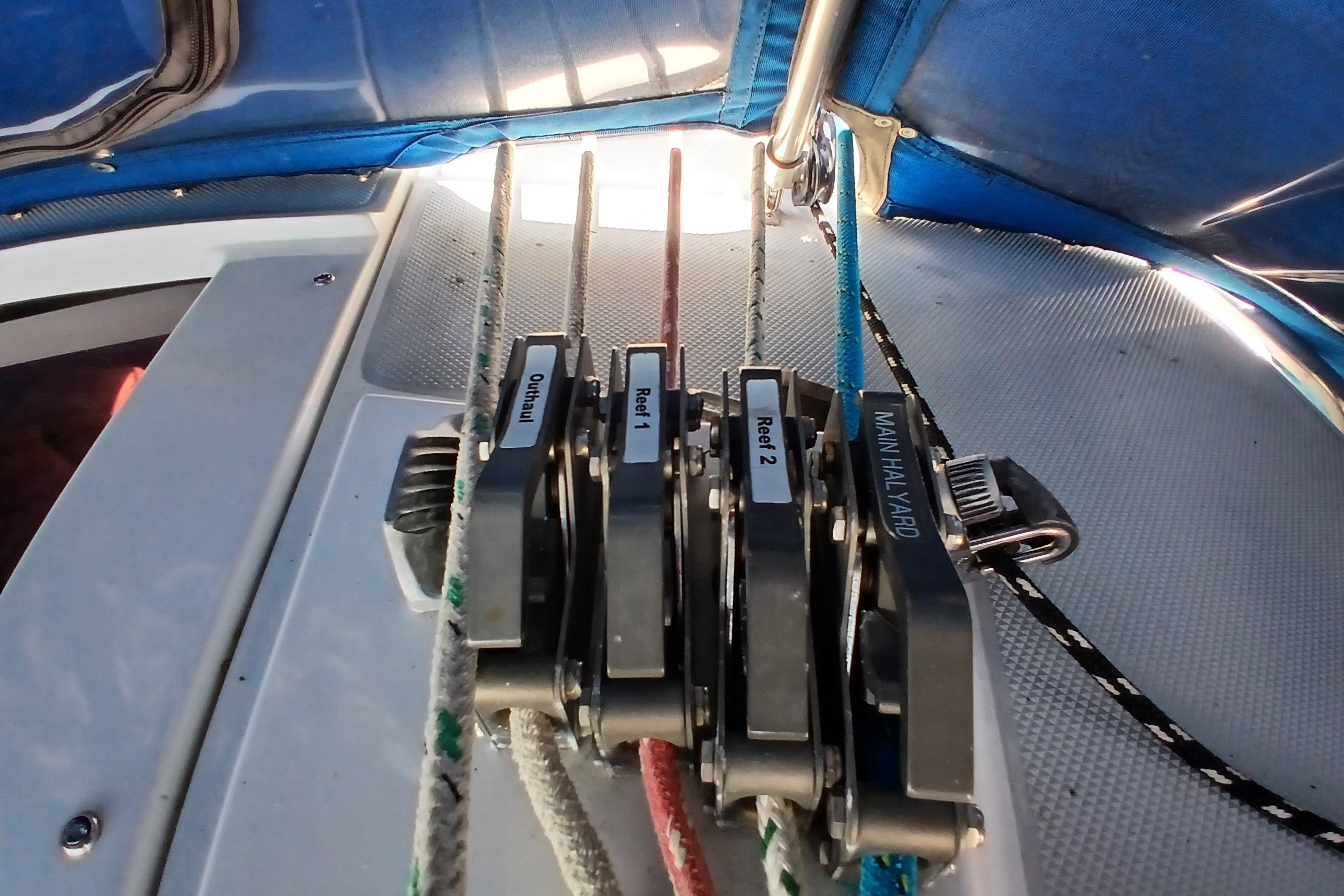 Close-up of sailboat rigging on a 1995 Catalina 42 MkII, featuring labeled rope clutches.