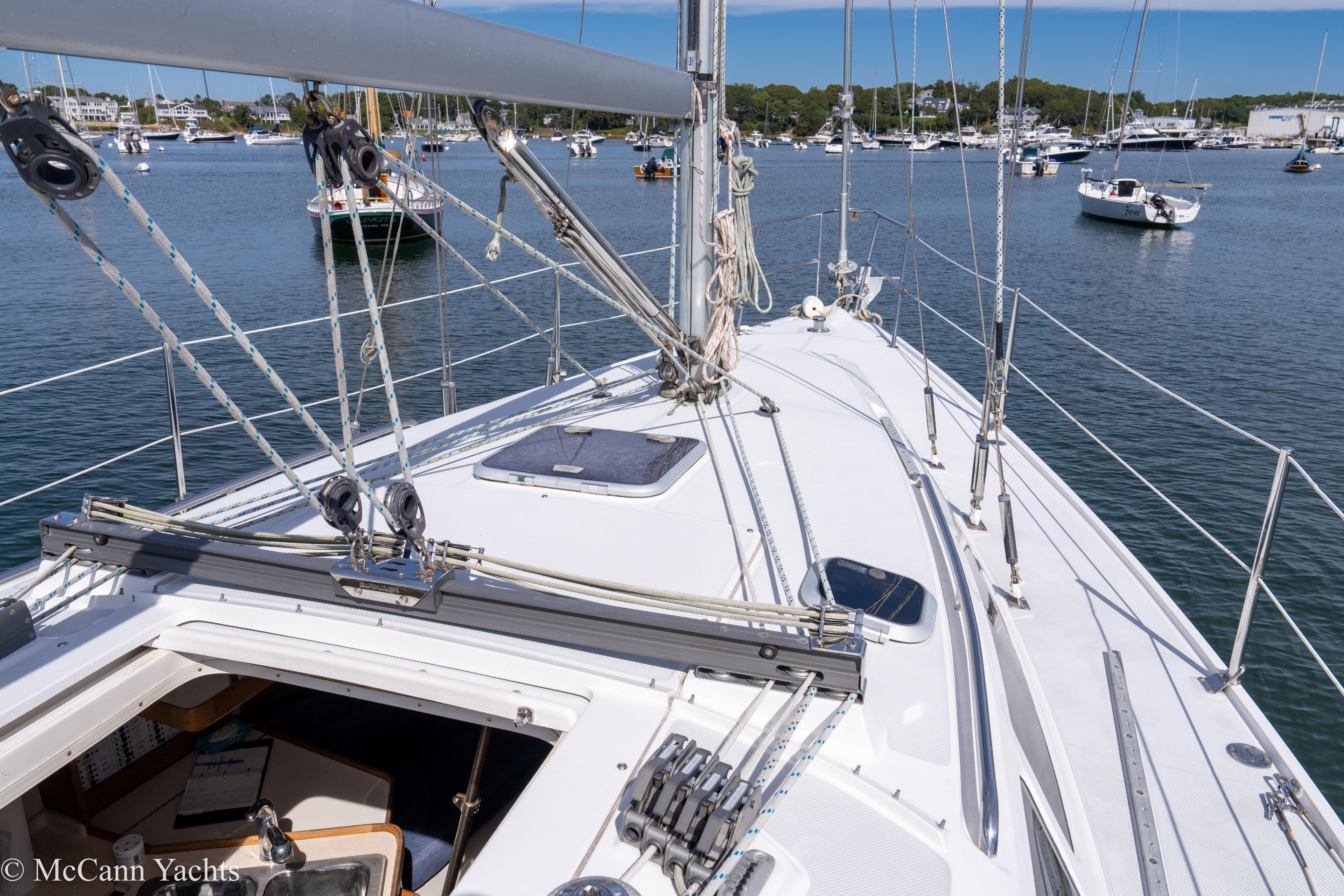 2003 Catalina 320 sailboat deck view in a marina with other boats.