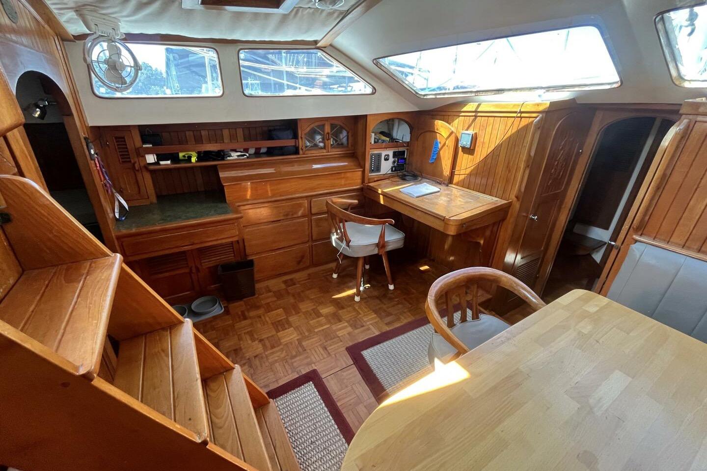 Interior of a 1979 Hardin 44 sailboat with wooden furnishings and natural light.
