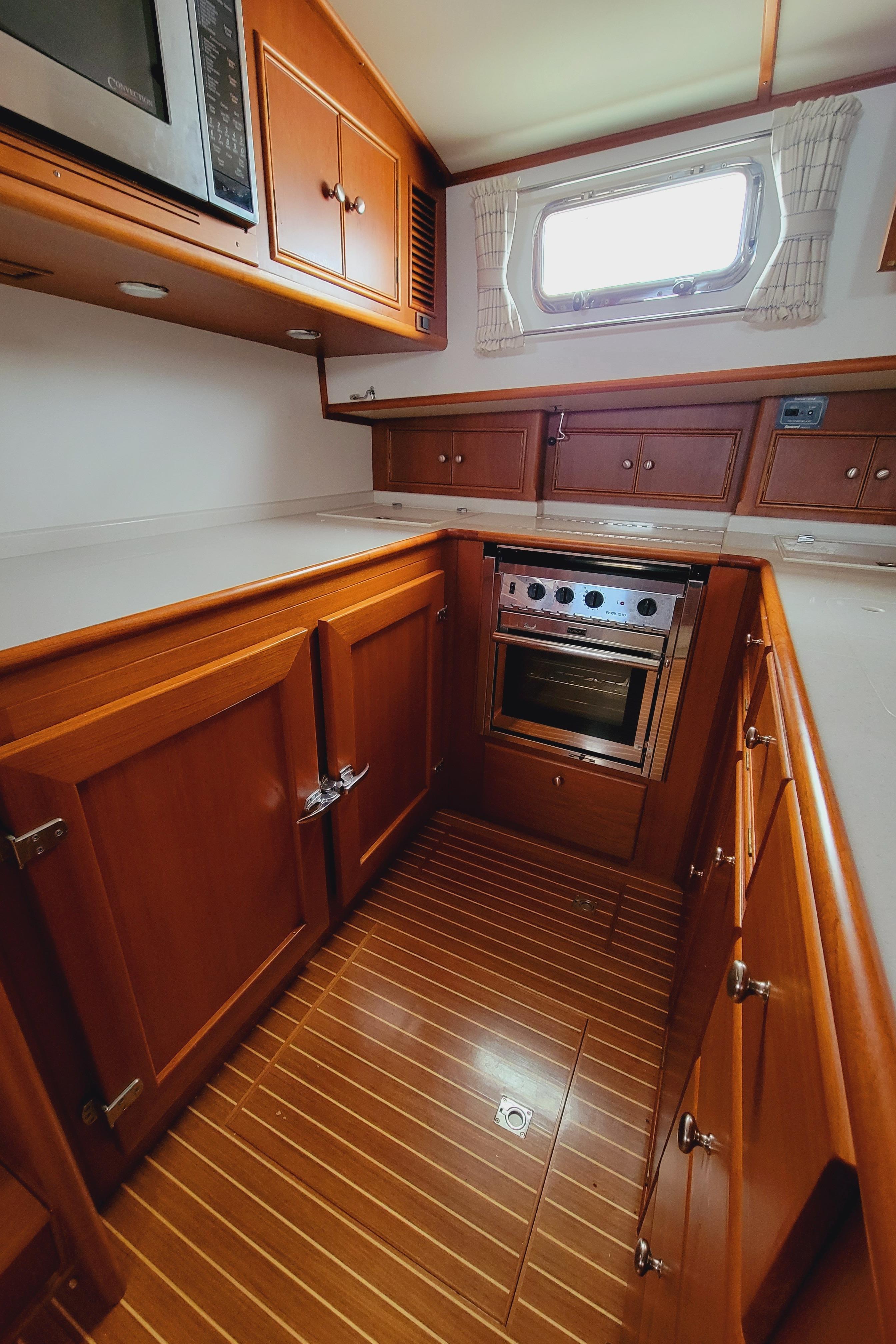 2004 Grand Banks 49 Eastbay HX kitchen with wooden cabinets.
