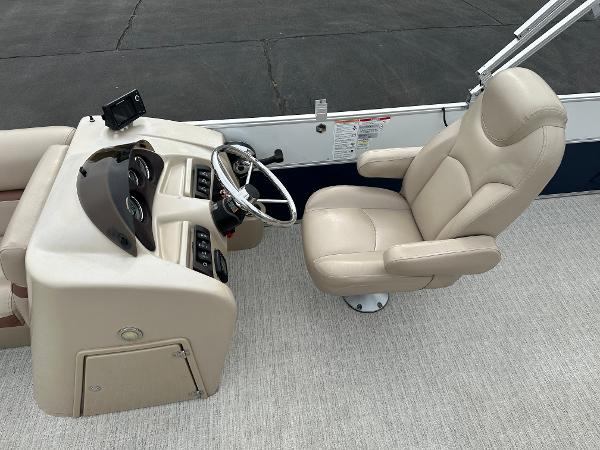 The image shows the helm of a 2018 South Bay S224CR boat with a beige captain's chair.