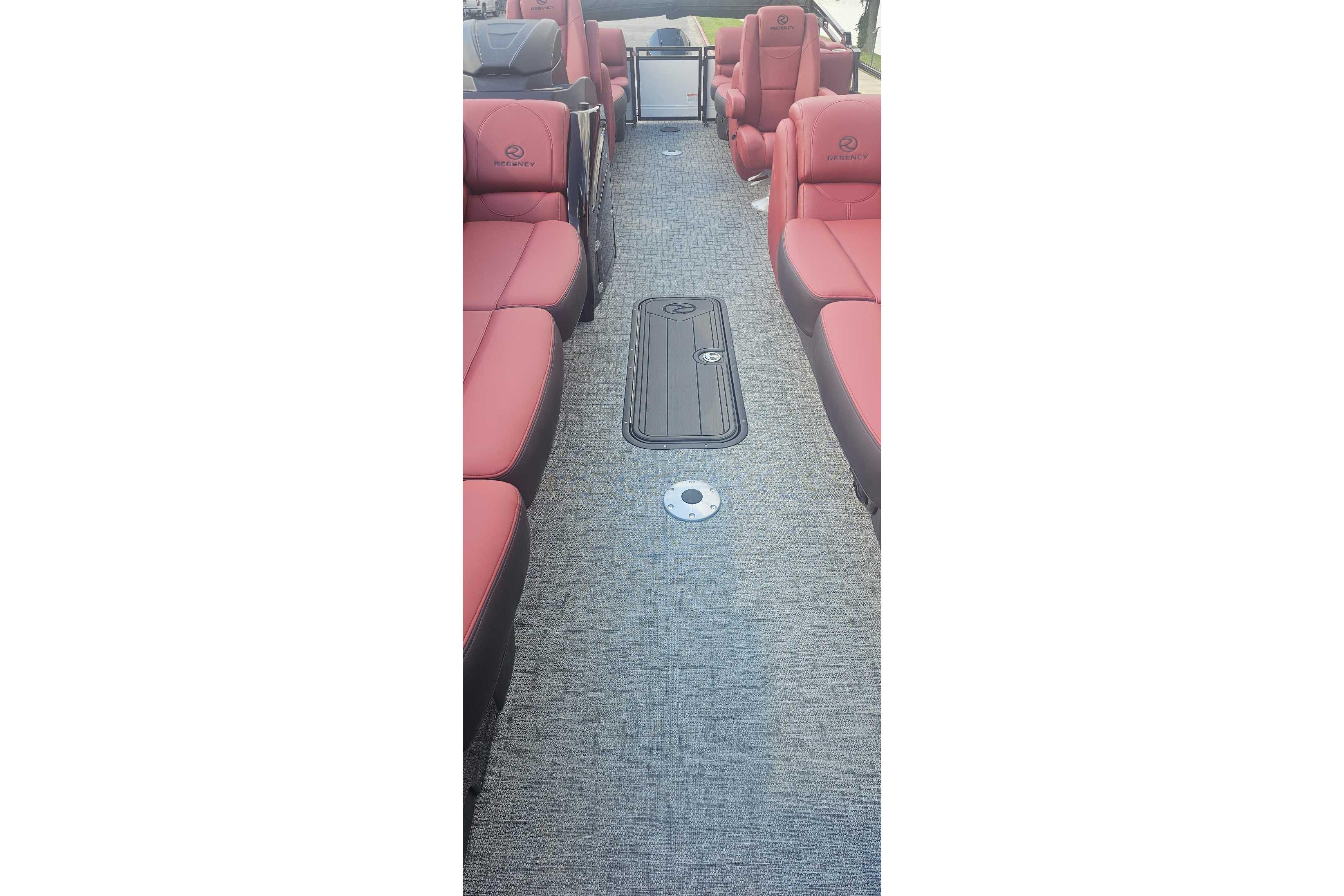 Luxurious interior of 2026 Regency 250 DL boat with red seating and gray flooring.