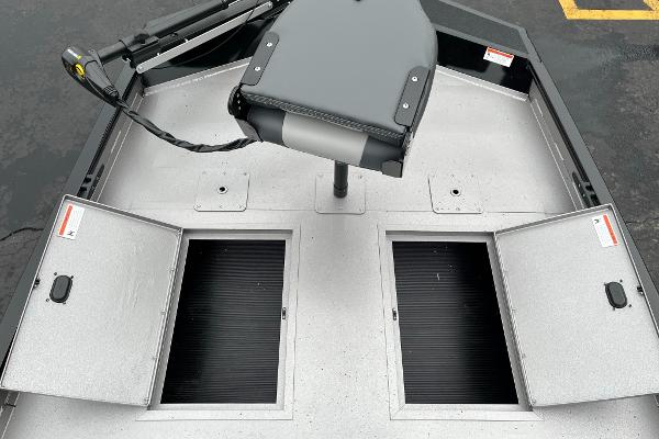 2024 Lowe Legacy boat deck with open storage compartments and seat.