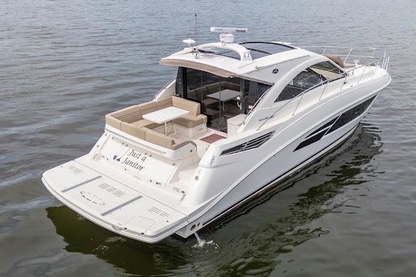 2016 Sea Ray Sundancer 510 yacht cruising on calm waters, showcasing sleek design and spacious deck.