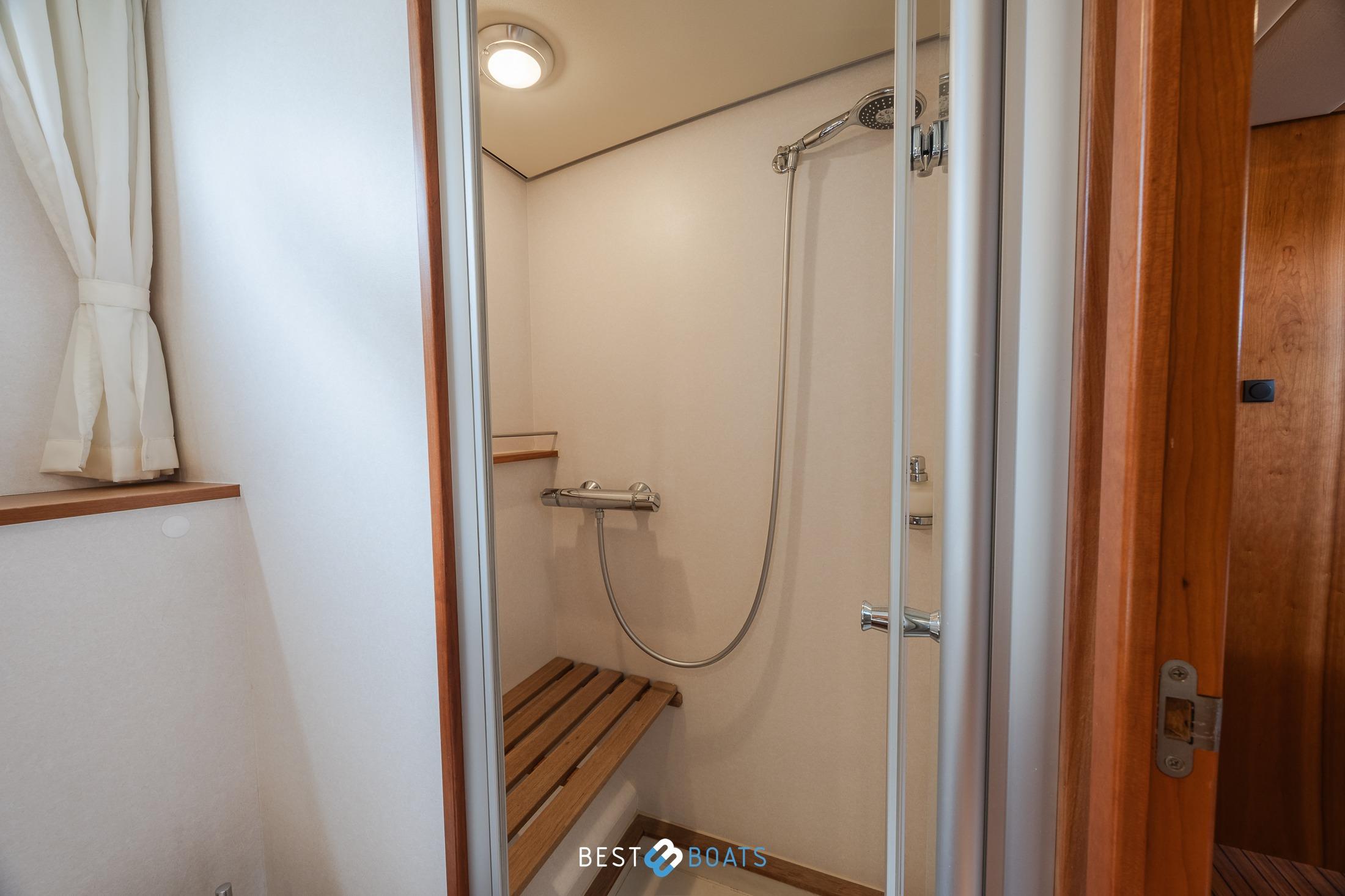 Shower area in 2010 Linssen Grand Sturdy 43.9 AC yacht with wooden bench.