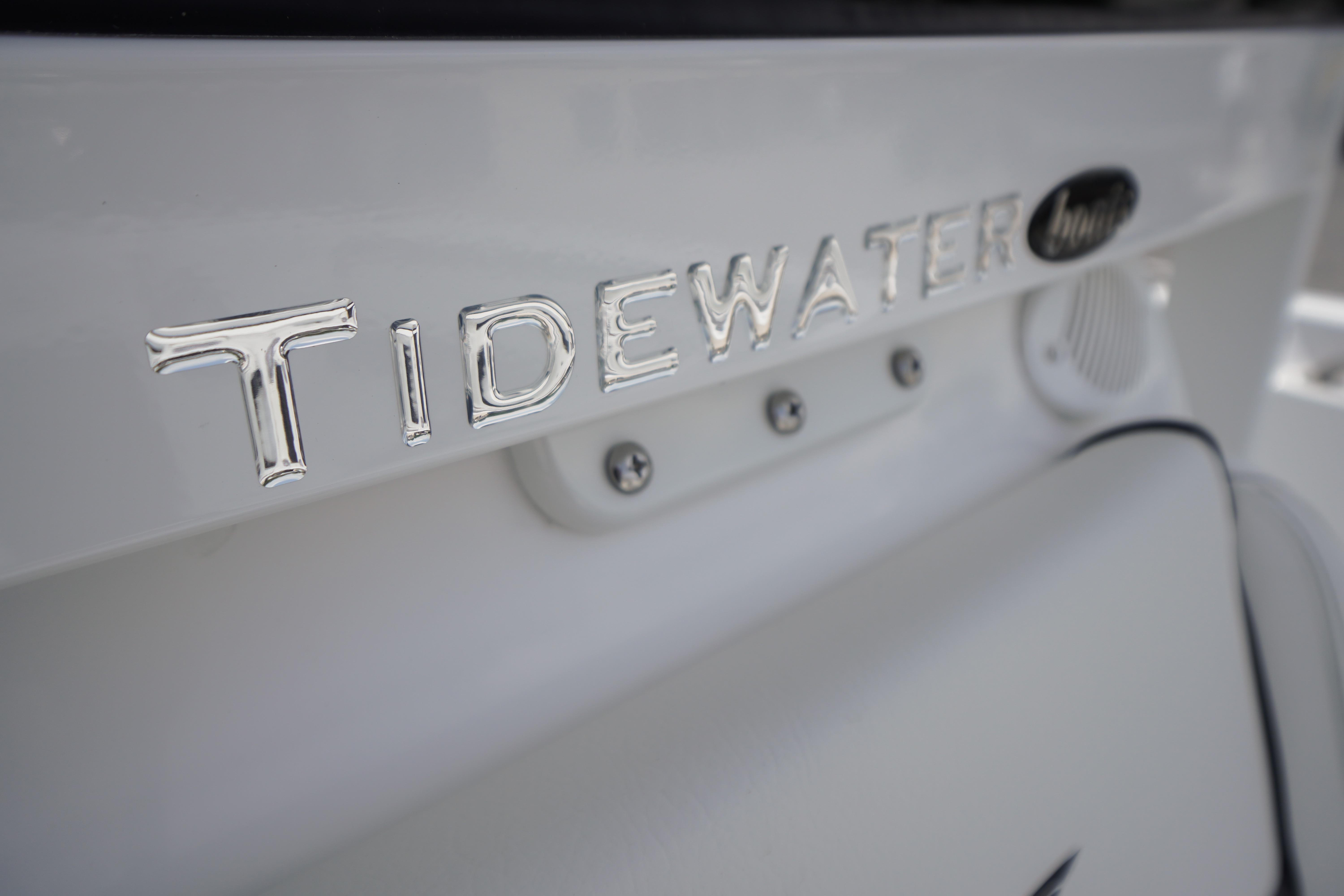 Close-up of 2027 Tidewater 220 CC Adventure boat logo on white surface.