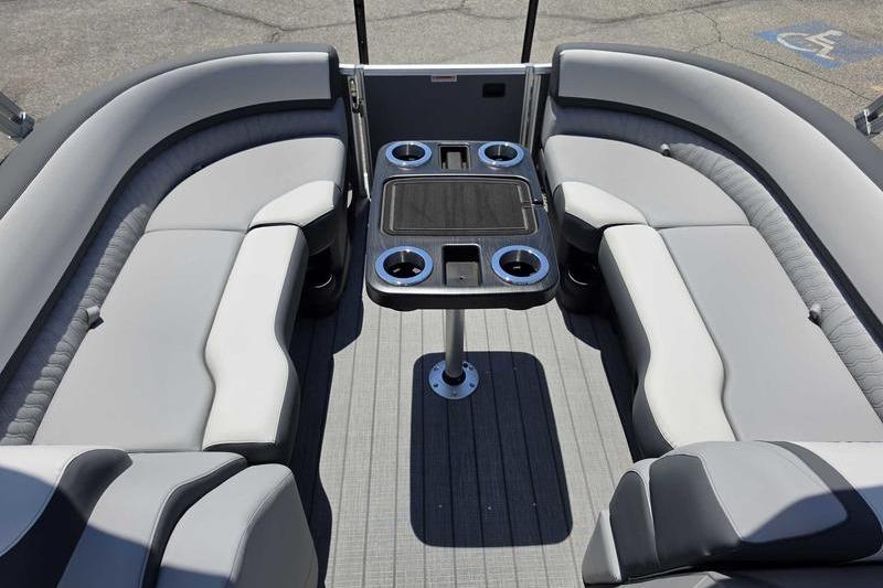 Luxurious seating area of 2026 Avalon Catalina Quad Lounge Shift boat, featuring modern design and cup holders.