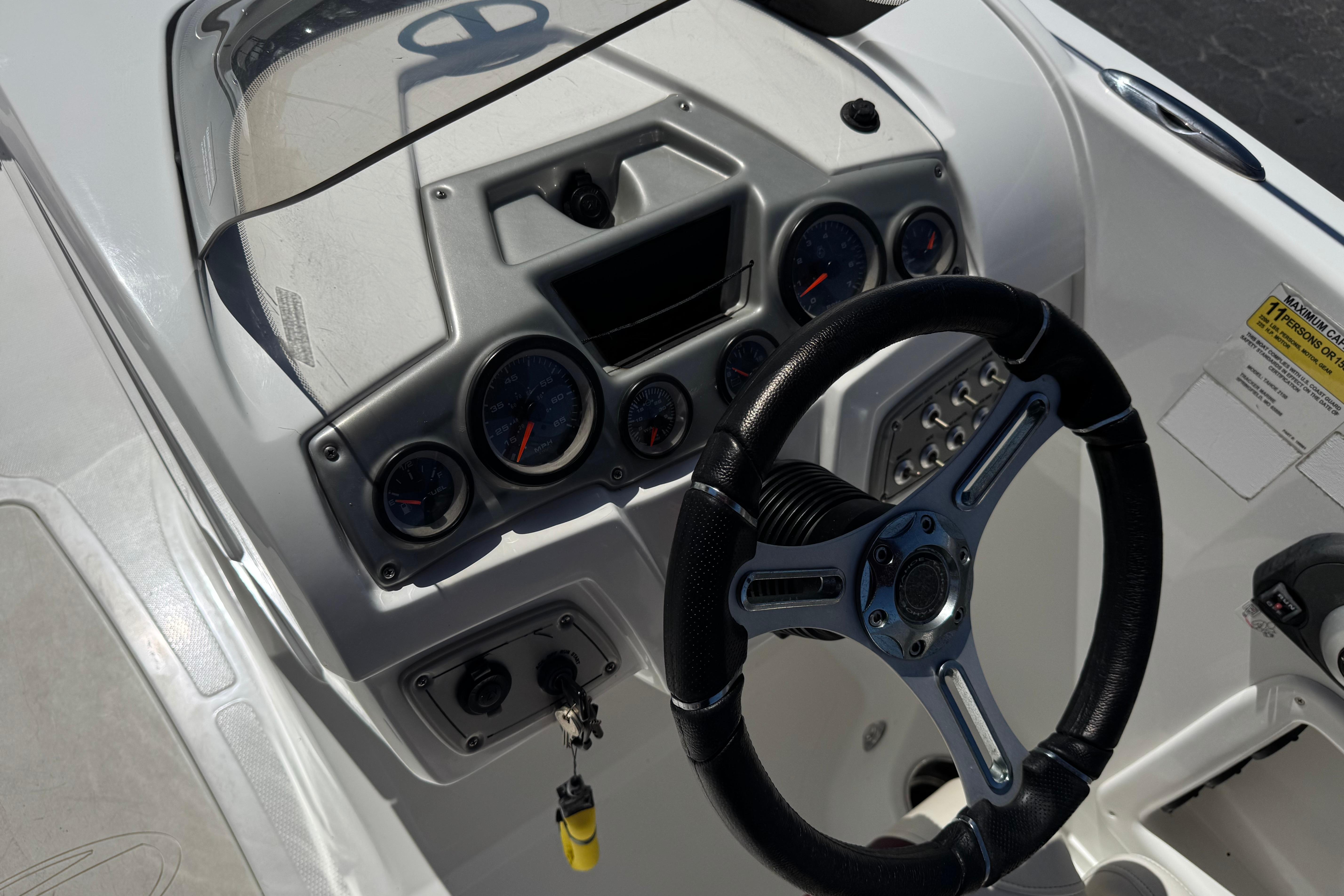 2017 Tahoe 2150 boat dashboard with steering wheel and instrument panel.