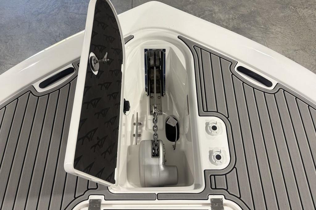 2026 Tidewater 3100 Carolina Bay boat anchor compartment with open hatch and sleek deck design.