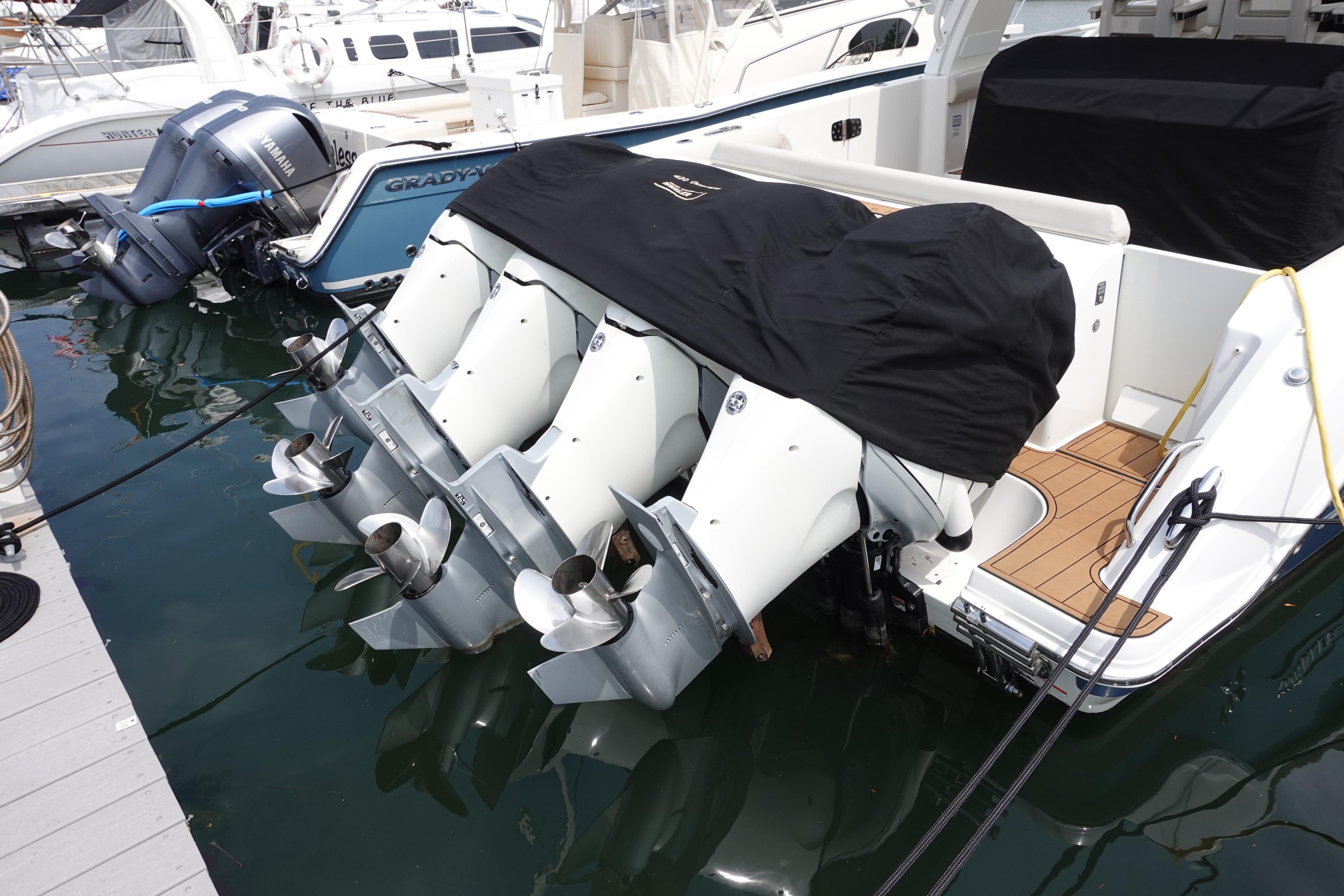 2020 Boston Whaler 420 Outrage with covered engines docked at marina.