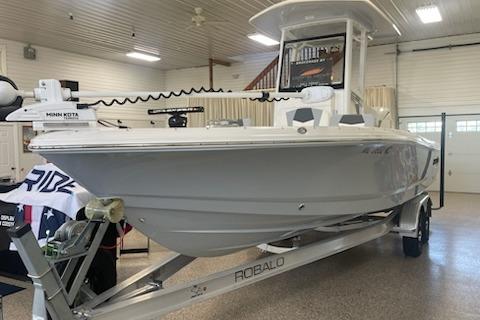 2024 Robalo 246 Cayman boat on trailer in indoor showroom.