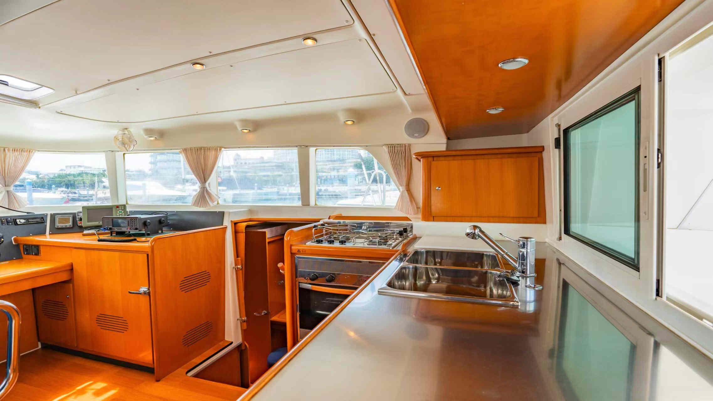 Interior of 2007 Lagoon 440 catamaran with modern kitchen and navigation area.