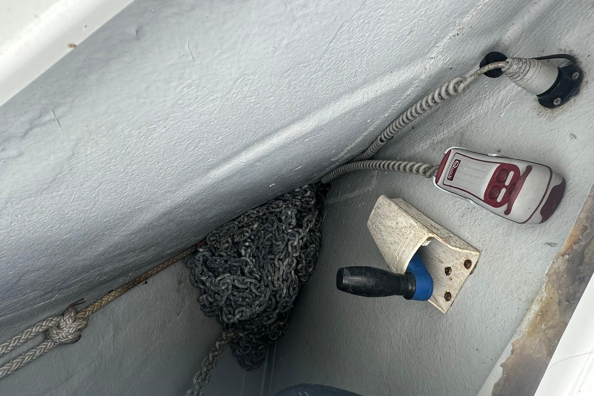 Storage compartment of a 2011 Beneteau Swift Trawler 34 Fly with coiled chain and equipment.