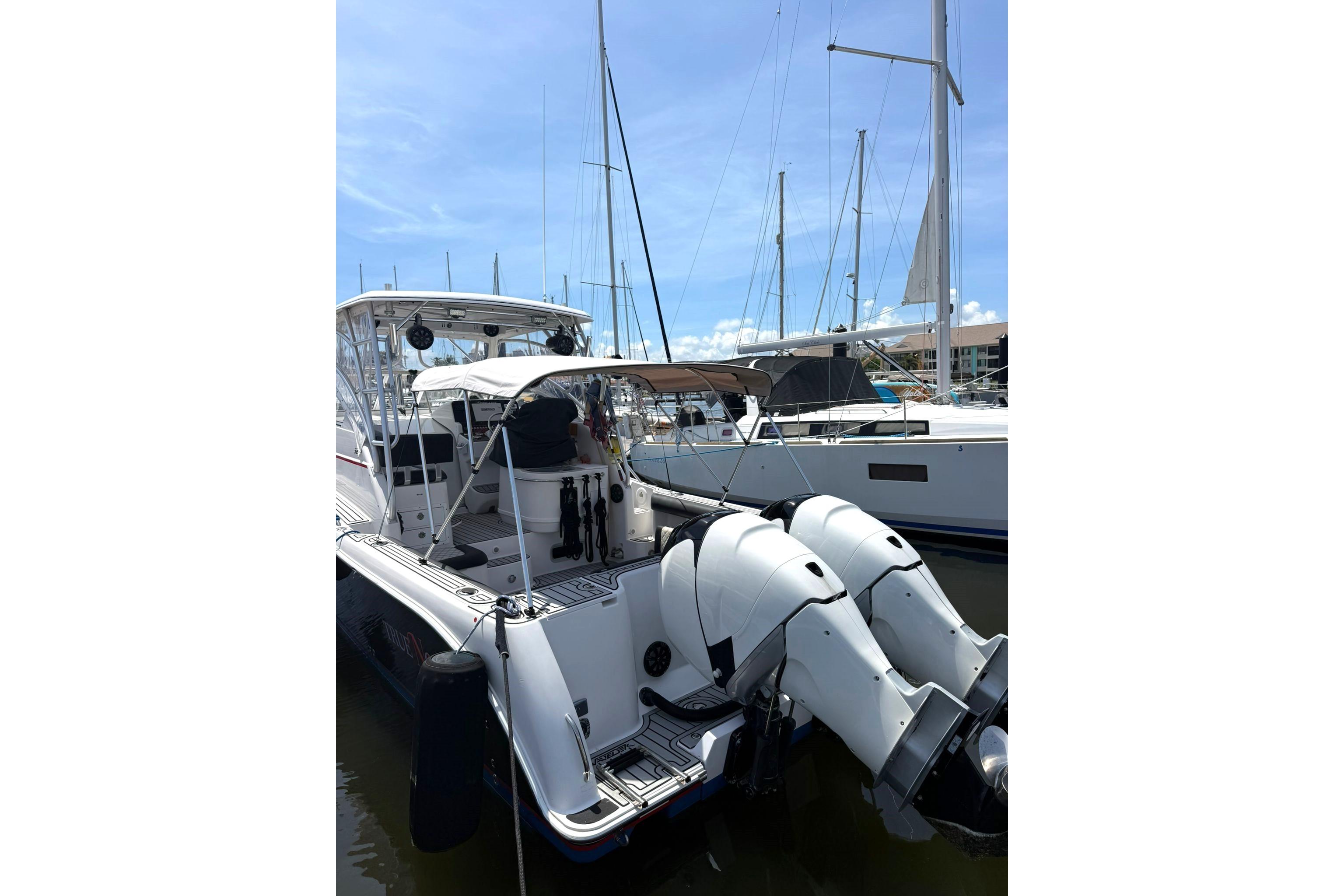 2006 Pro-Line 32 Express boat docked with dual outboard engines.