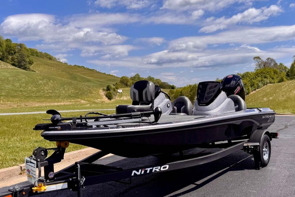 2026 Nitro Z17 boat on trailer, parked on scenic road with green hills.