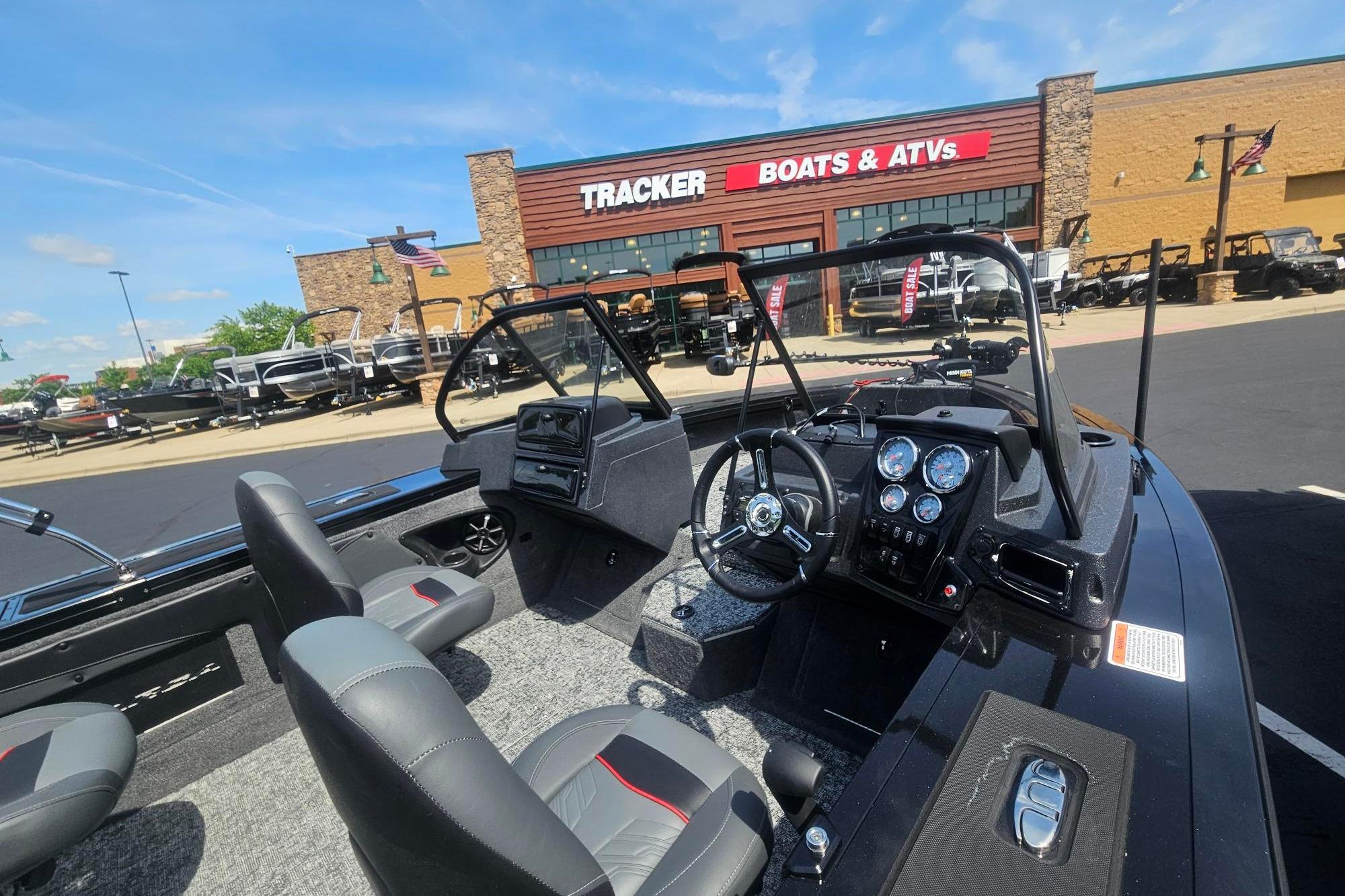 2026 Tracker Targa V-19 Combo boat interior at dealership, showcasing dashboard and seating.