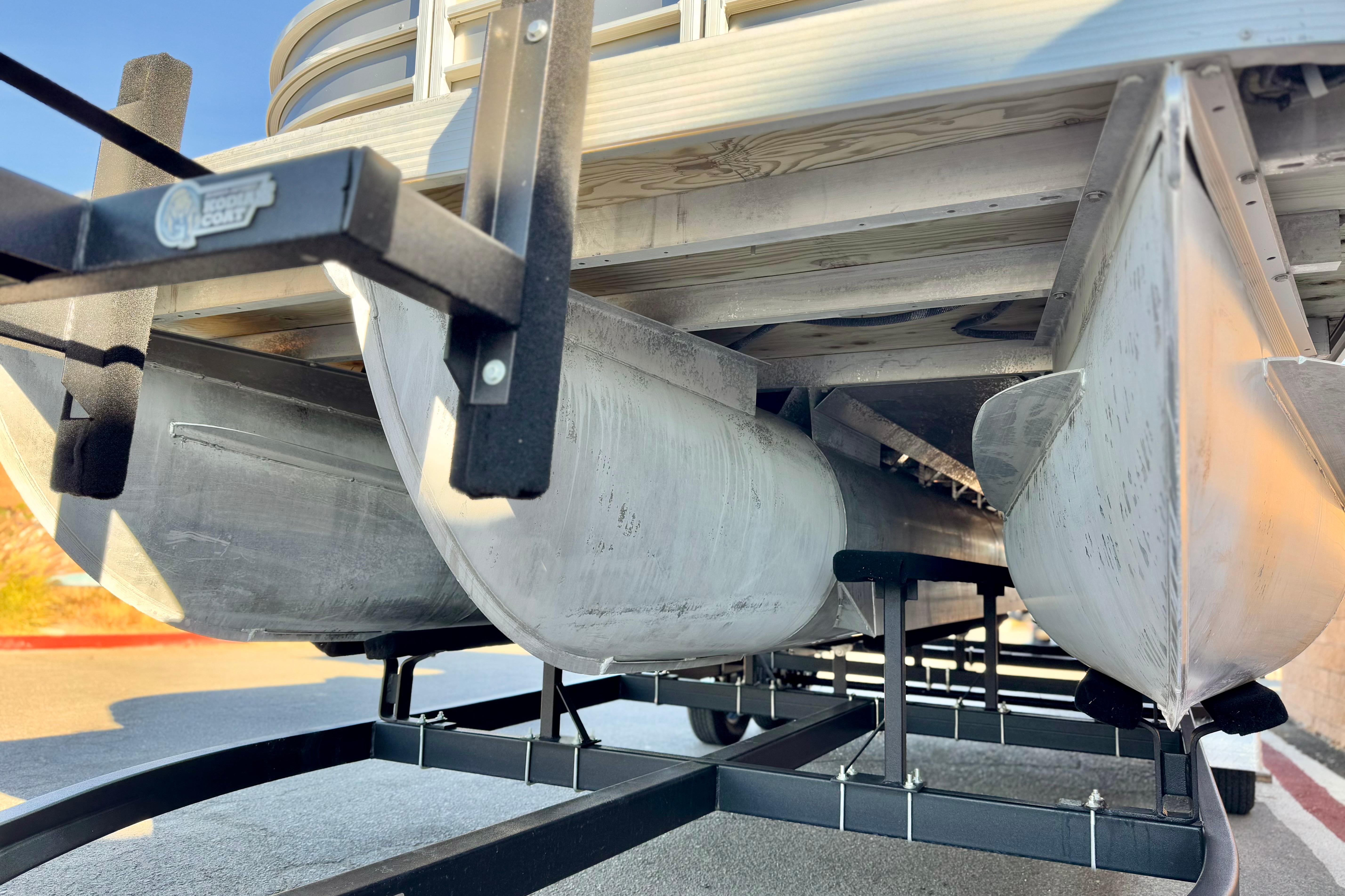 2021 Bennington 23LSR pontoon boat on trailer, close-up of pontoons and frame.