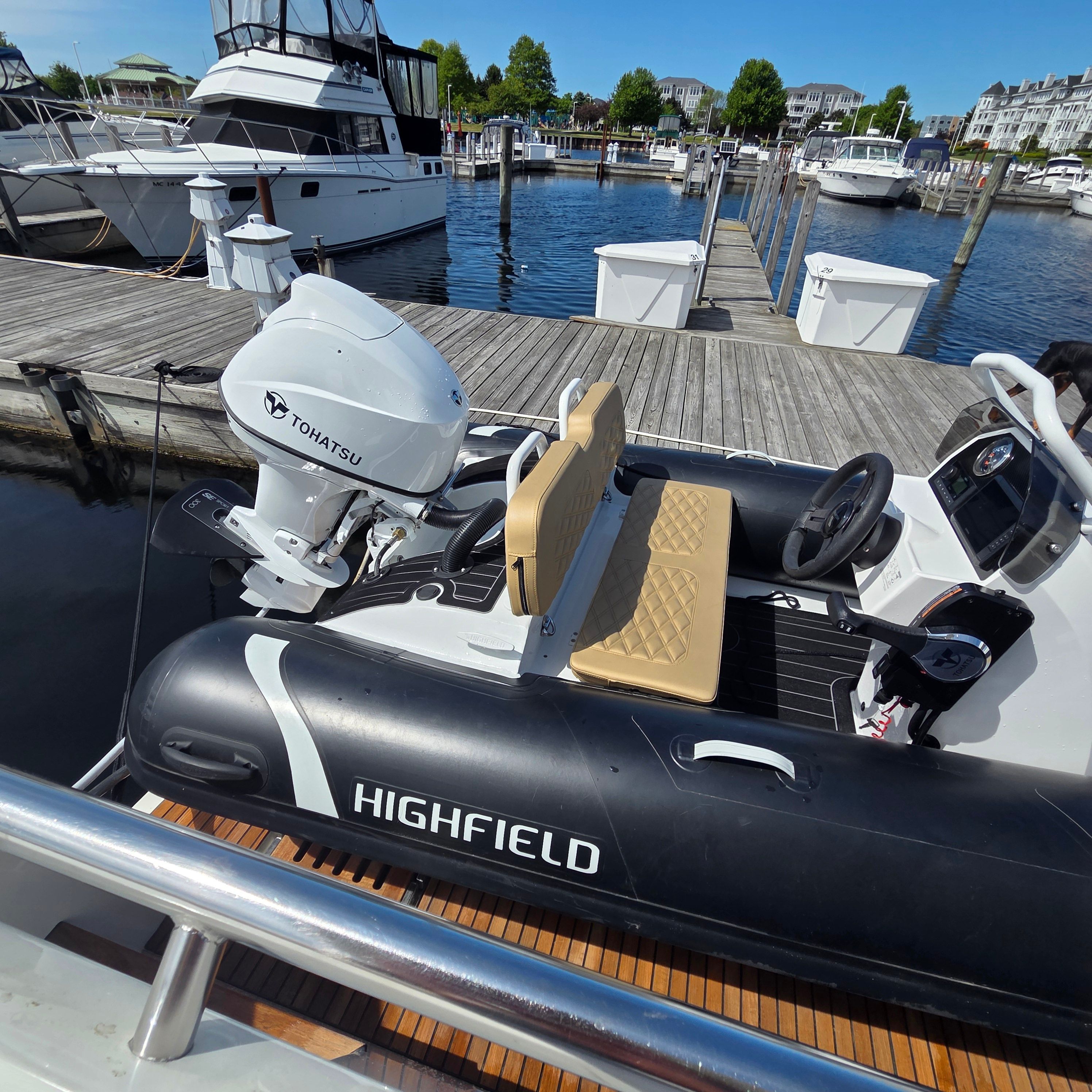 2024 Highfield Sport 390 inflatable boat docked with Tohatsu engine.