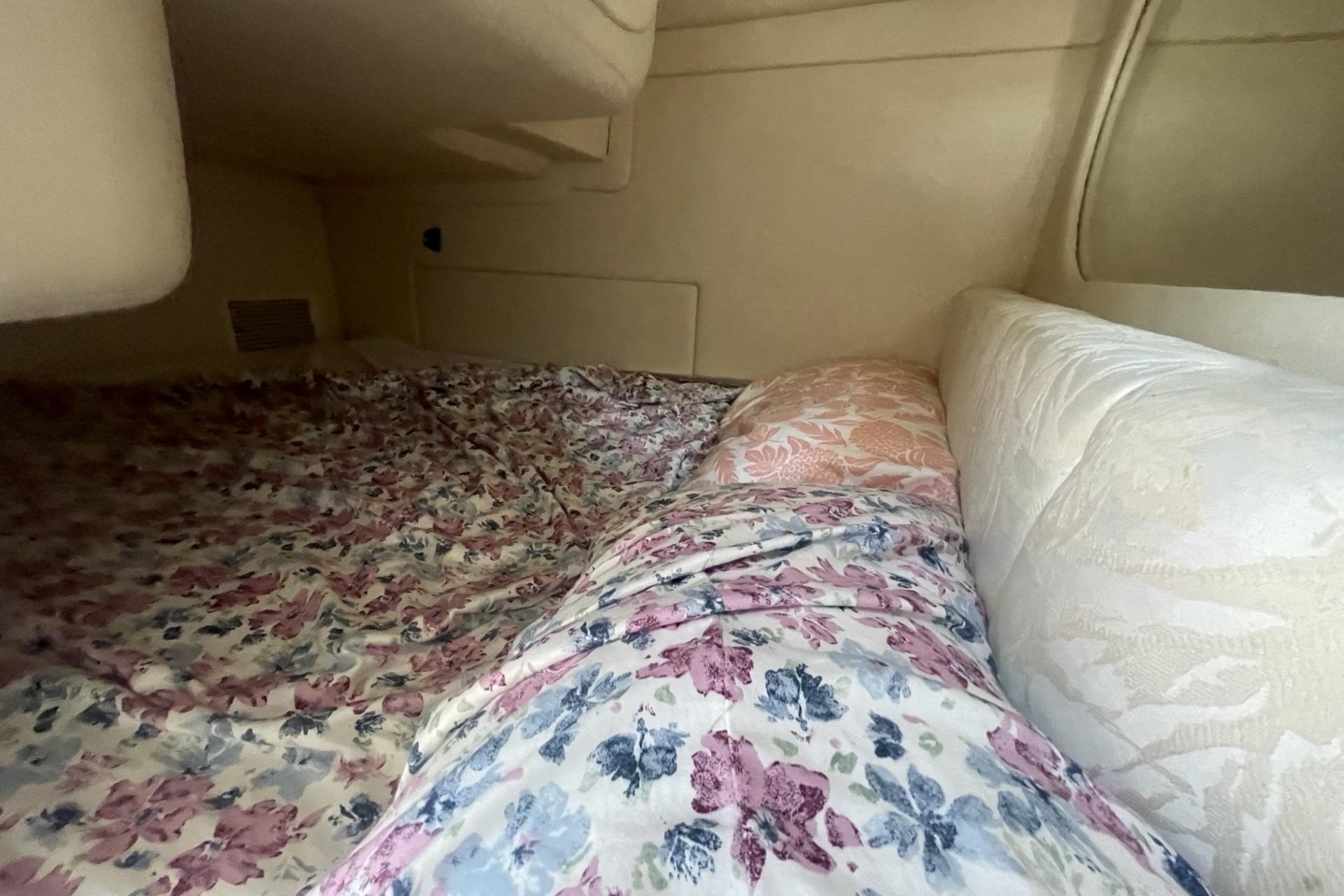 Interior cabin of 2000 Sea Ray Sundancer 260 with floral bedding.